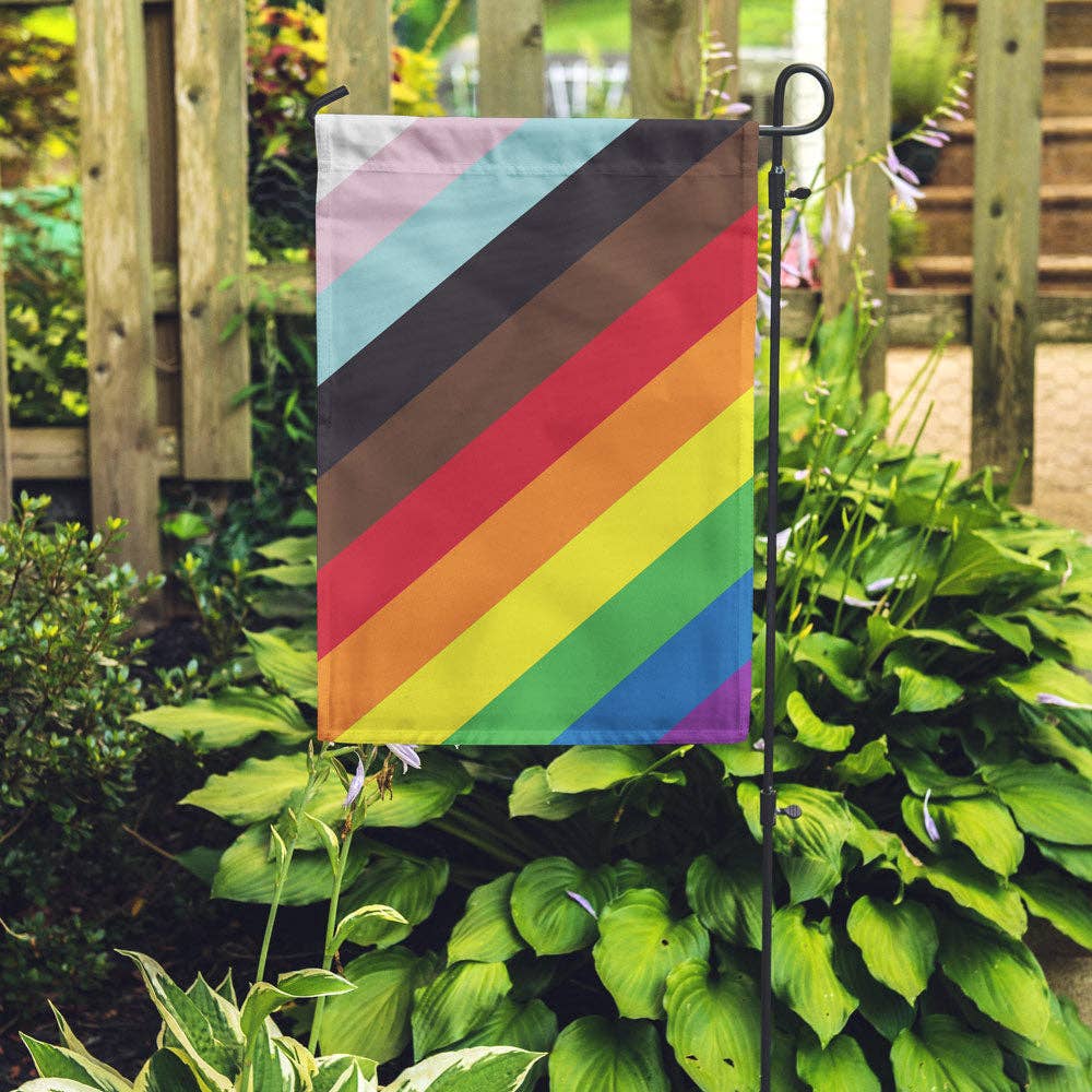 The 11-Stripe Diagonal Pride Flag by Flags For Good turned into a cute vertical garden flag with standard pole pocket along the top. Flags for good took the traditional 6-Stripe Rainbow flag popularized by Gilbert Baker, added the black and brown stripes from the Philadelphia Pride Flag, and then topped it with the turquoise, pink, and white from the Trans Pride Flag and turned them 45 degrees to make a beautiful new diagonal pride flag! 18" x 12"