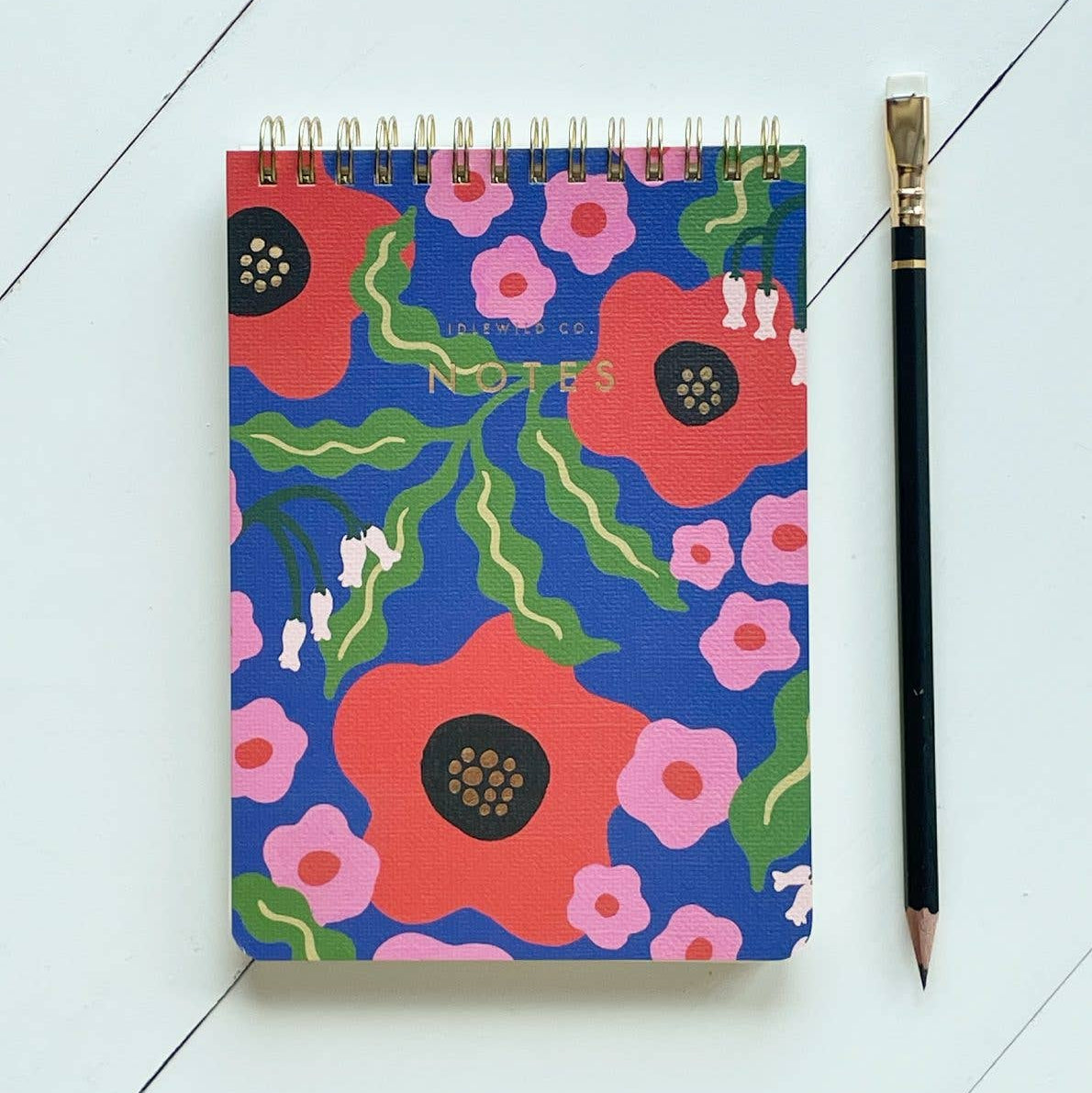 Notebook with floral design on a light blue background