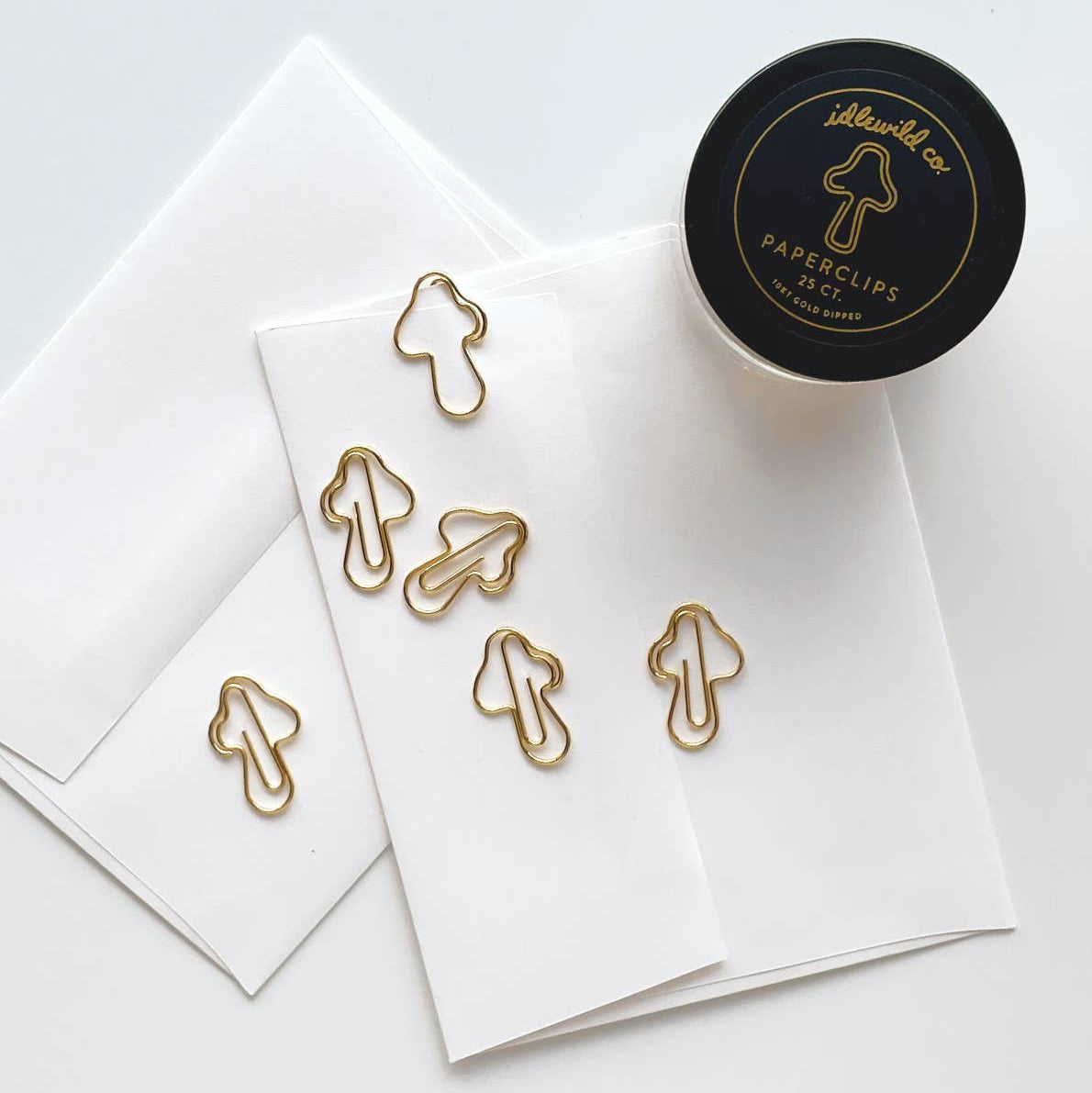 Our fun and quirky paper clips make all of your office &amp; school work just a bit more–if not exciting–than at least more aesthetically pleasing.

Small glass jars are filled with 25 mushroom shaped, 10k gold clips to dress up your desk, homework, bills, planners–anything you can think of!

• Glass Jar of 25-pieces

• Clips approximately .75" x 1"