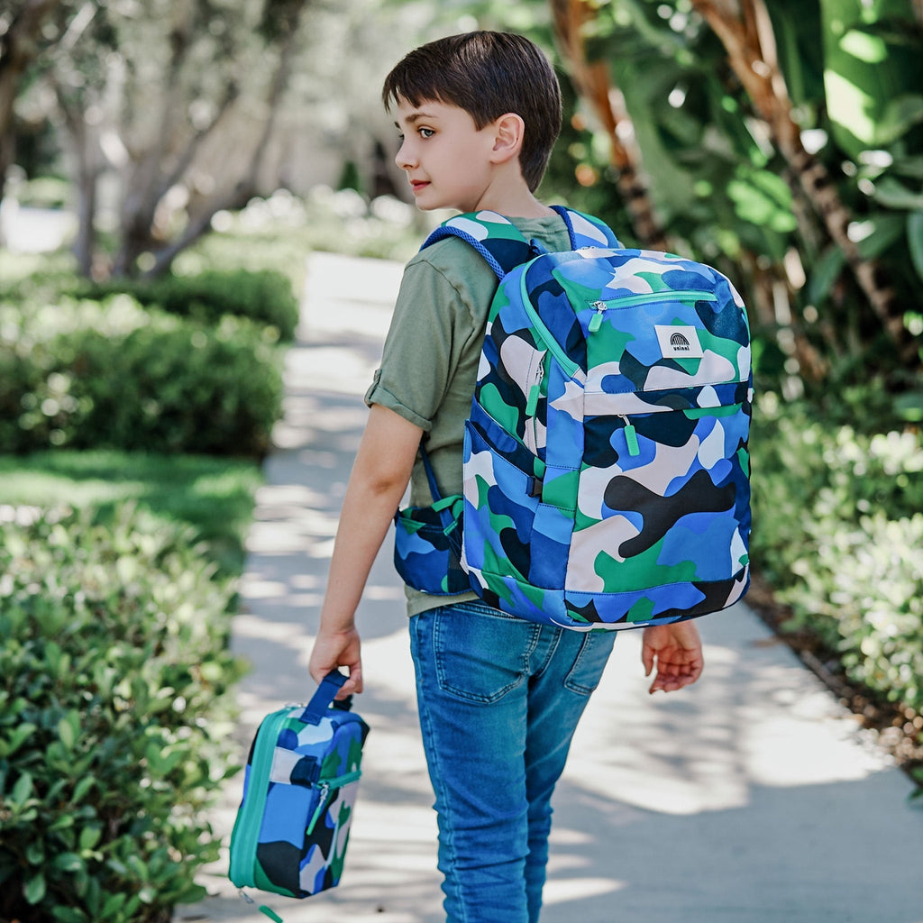 Get ready to carry your belongings in style with the Bailey Backpack in Camo Kid Blue/ Green With its sleek design and durable construction, this backpack is perfect for any adventure. Plus its the Camo Kid Blue/ Green color adds a touch of fun to any outfit. Don't miss out on this must-have accessory!