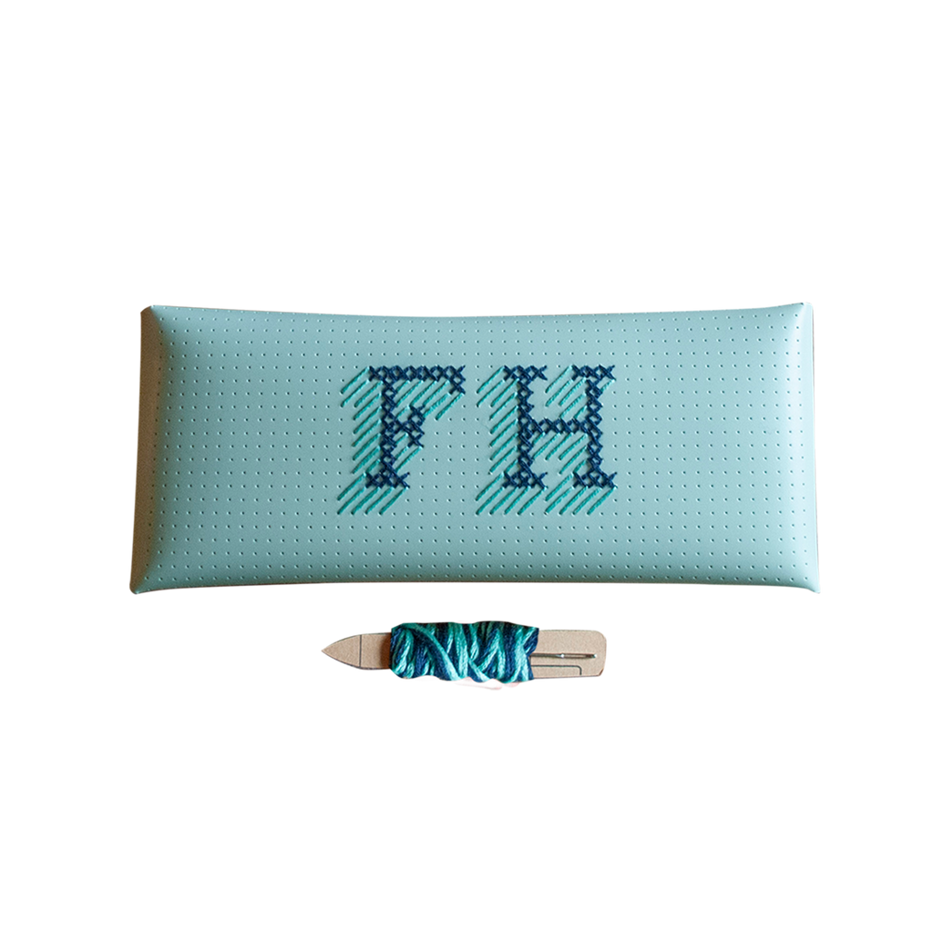 Stitch your own way - this envelope pocket is ideal as a pencil or glasses case and allows you to sew any unique design. Whether you stitch initials, a slogan or the sunglasses template included, it opens out fully for easy stitching. It also opens 2 ways, so it can open from the side or from the top - just pop the metal buttons to fold up whichever way you prefer. The Mint pouch comes with teal & navy thread &amp; needle wrapped on our pen thread-board. It includes our 3D alphabet template to add initial