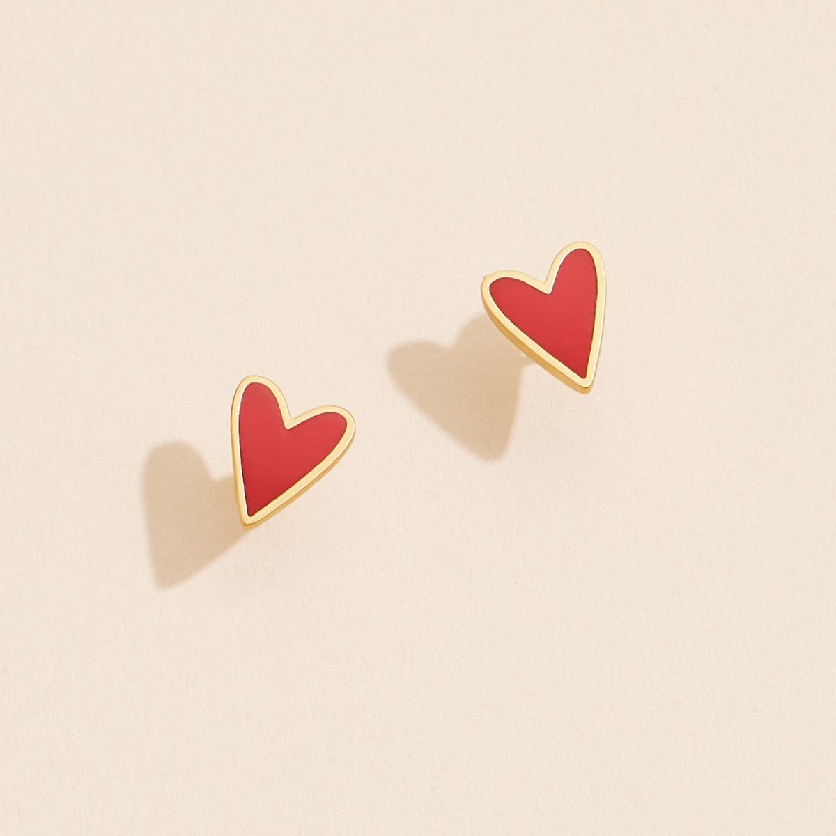 Fall in love with our Enamel Heart Shaped Stud Earrings! These charming earrings feature delicate enamel hearts that add a touch of loveliness to any outfit. Treat yourself or your loved one with these beautiful studs today!
