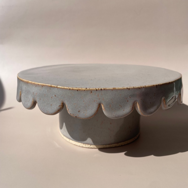 gray ceramic cake stand with scalloped edges