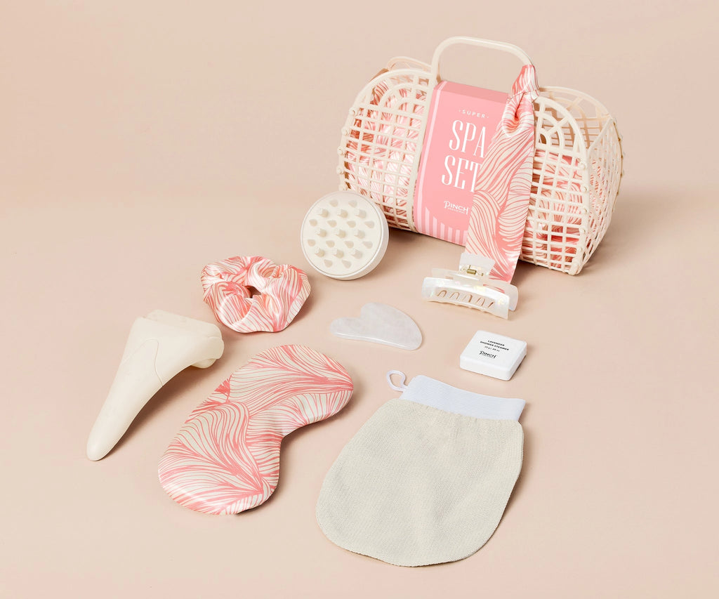 Pinch Provisions new Super Spa Set are the ultimate "self-carryall". The ivory jelly tote features an inner drawstring bag containing the perfect deluxe assortment of 8 spa essentials: full-size ice roller, silk sleep mask, gua sha, exfoliating mitt, hair clip, shower steamer, scalp massager and silk scrunchie.
