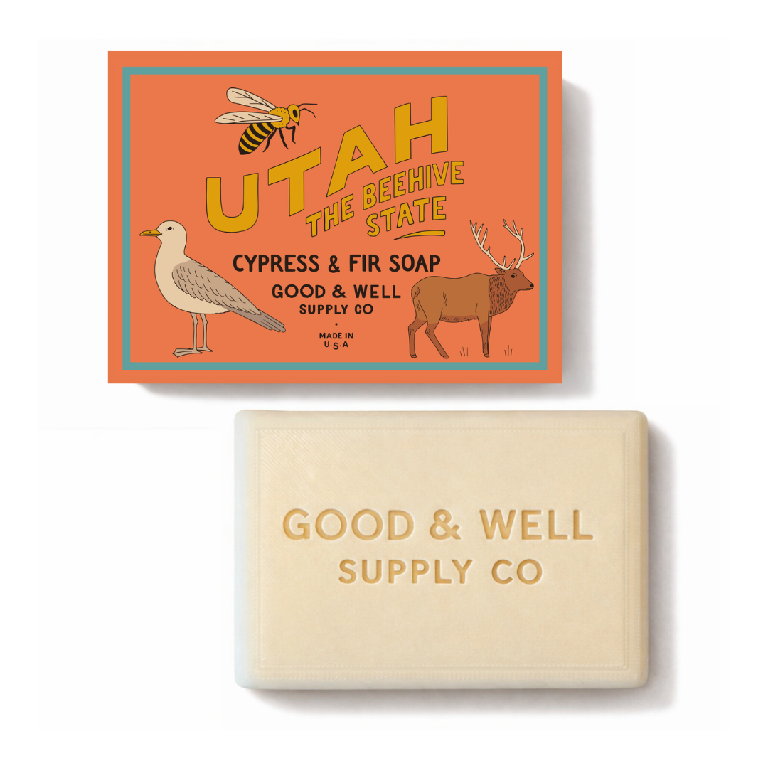Bar of soap with 'Good & Well Supply Co' branding and a decorative soap box featuring Utah-themed illustrations.