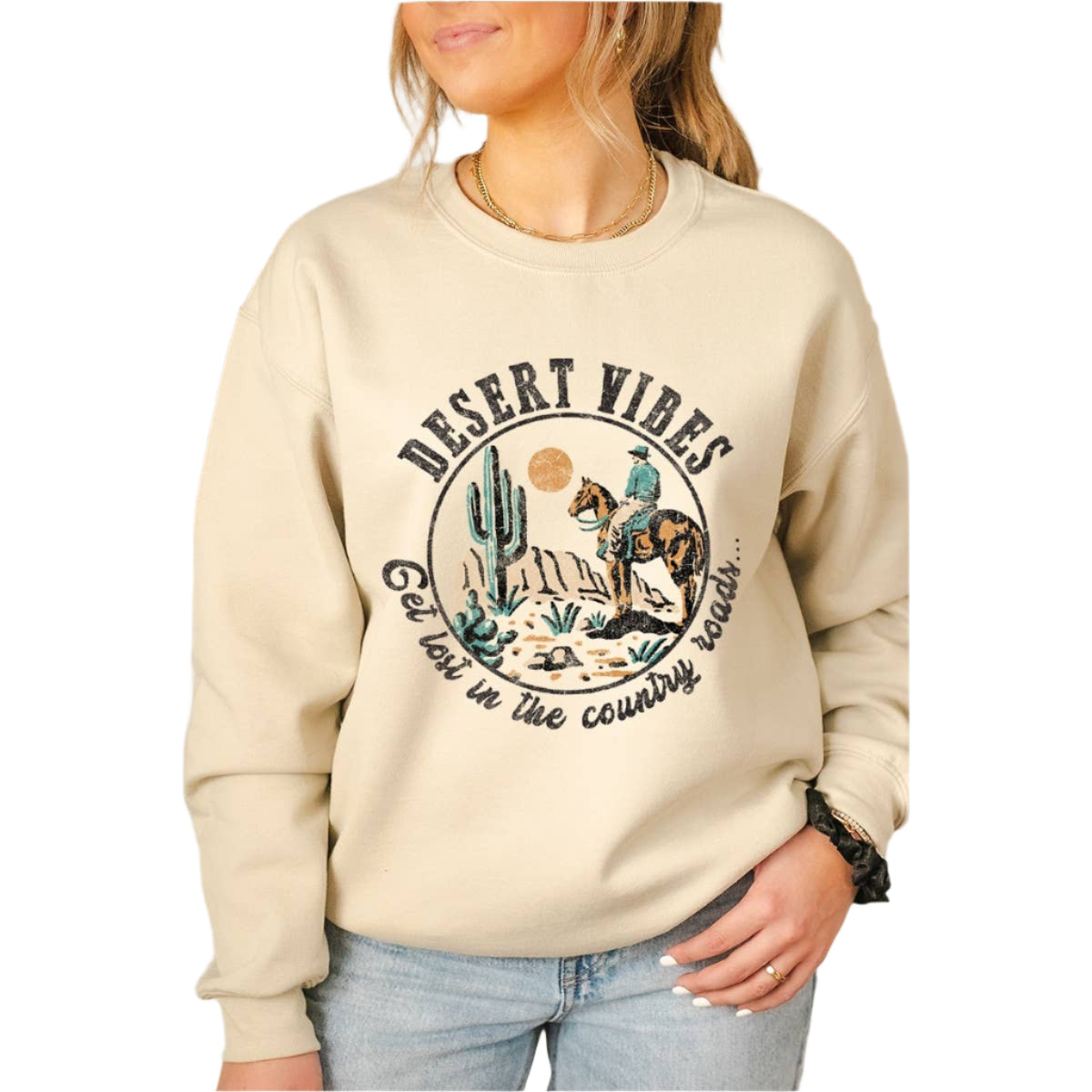 Beige sweatshirt with 'Desert Vibes' graphic and text worn by a person.