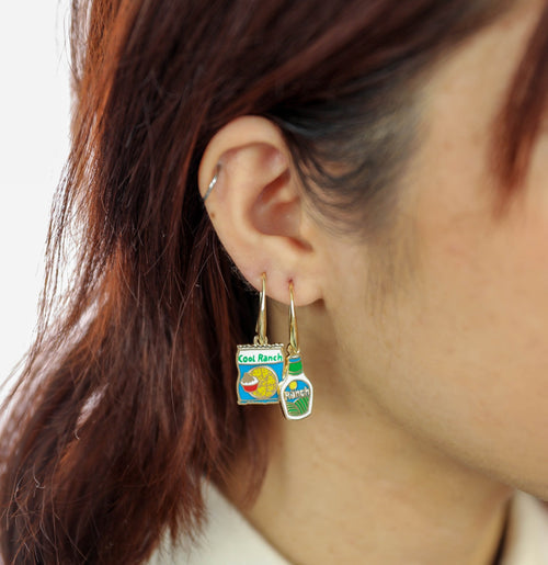 These earrings are for serious ranch lovers, no matter what form it takes. Wear one on each ear, or combine them on a double ear piercing!  Presented in a matchbook style gold foil box, our signature mismatched earrings feature 18k gold gilt enamel on hanging earwire. Hypoallergenic, nickel, lead, and cadmium-free! 