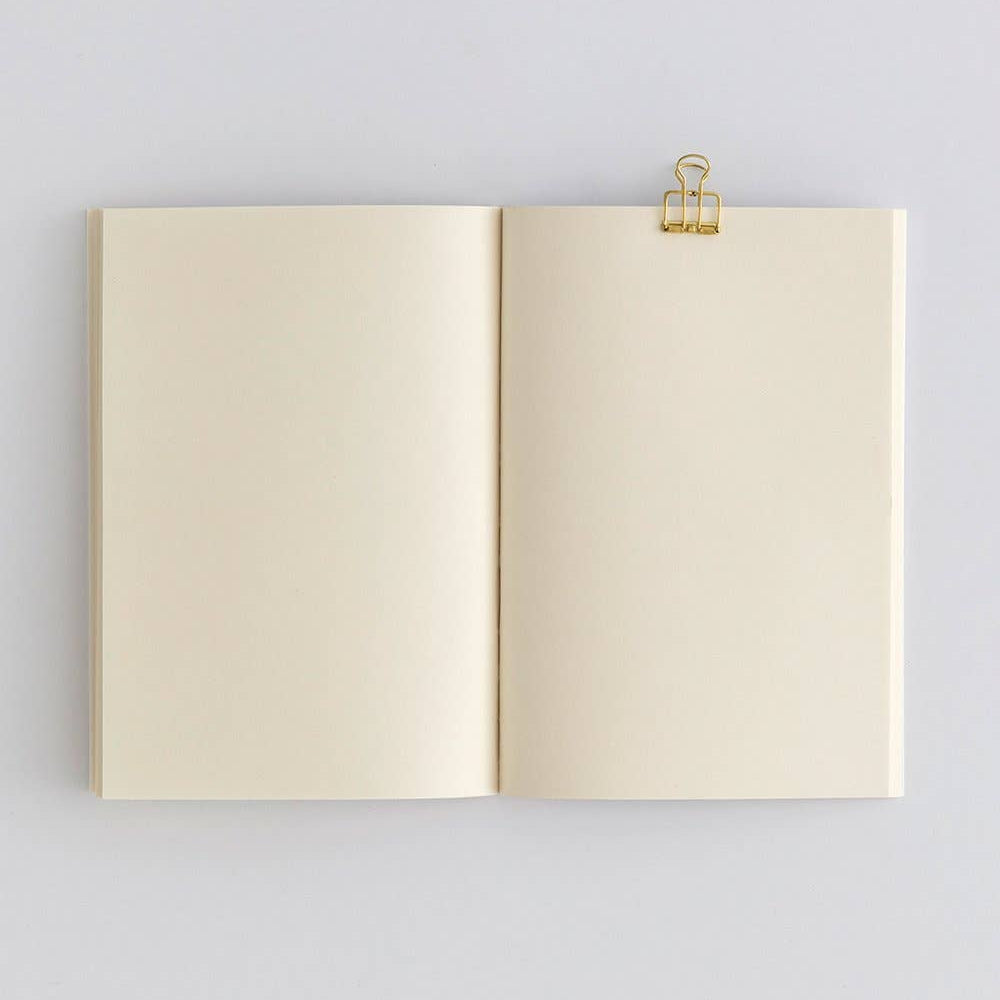 Open notebook with a gold clip on a light gray background