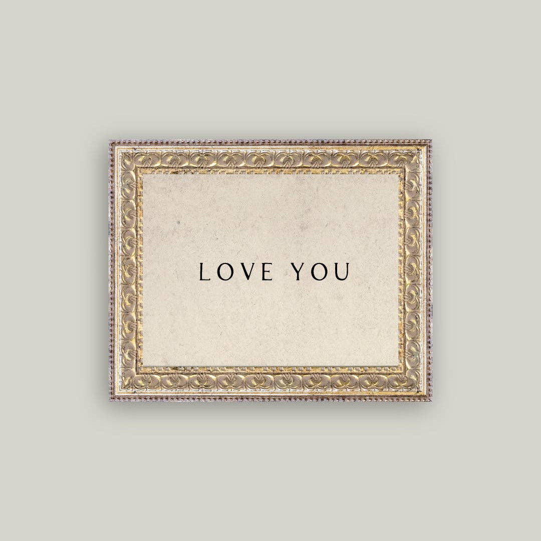 Display timeless affection with this charming framed art piece. Featuring an ornate vintage-inspired frame with warm cream tones, it brings nostalgic elegance to any room. The "Love You" sentiment makes it perfect for expressing care in bedrooms, living spaces, or as a heartfelt gift. The 10x8 size fits seamlessly on shelves, dressers, or walls, adding a touch of romantic, antique-style character to your décor.