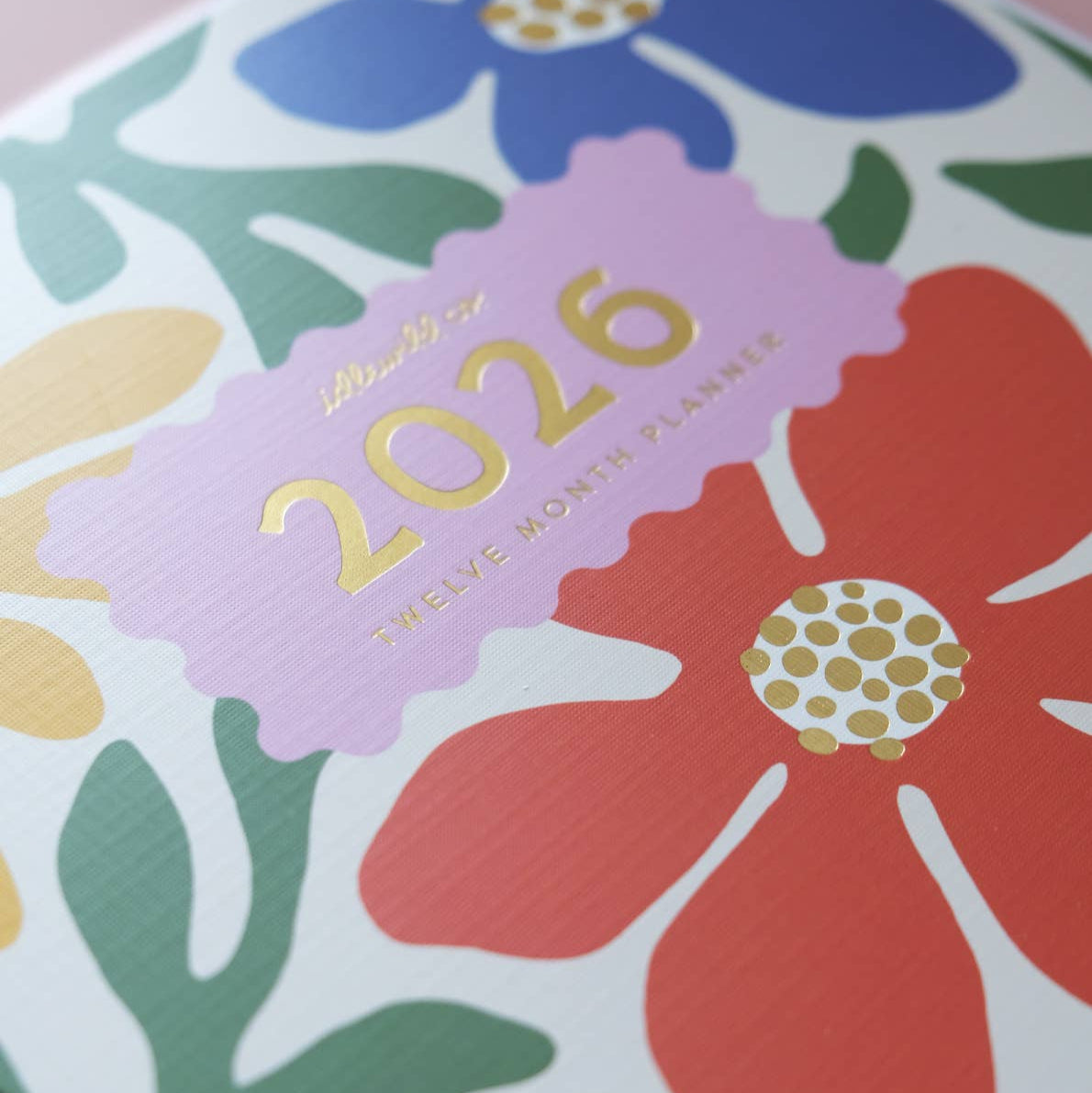 Floral design planner cover with '2026' text on a pink background
