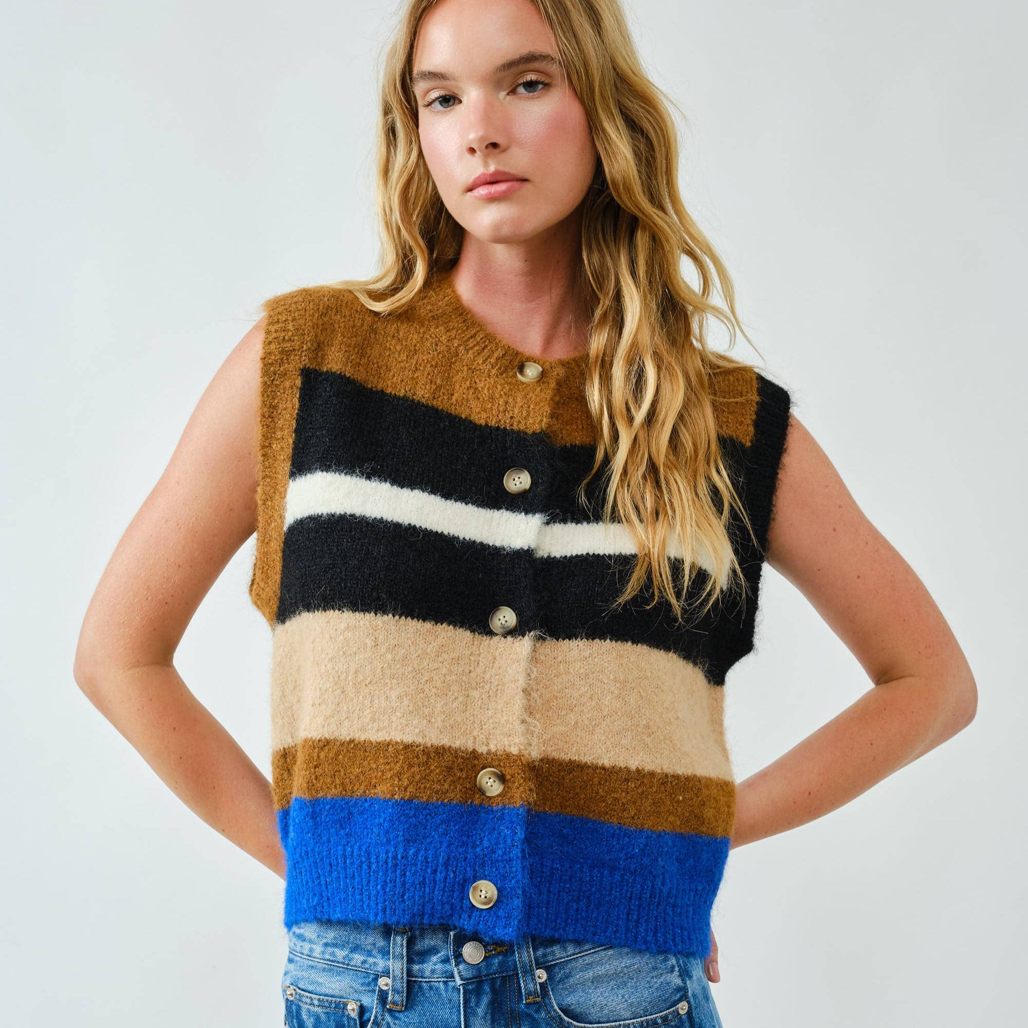 Cozy up in bold style with this soft pullover sweater vest, designed with striking multicolor stripes. The fuzzy knit texture adds warmth, while the relaxed fit and button-down front offer a laid-back, vintage-inspired feel. Whether layered over a shirt or worn on its own, this vest delivers both comfort and standout personality.