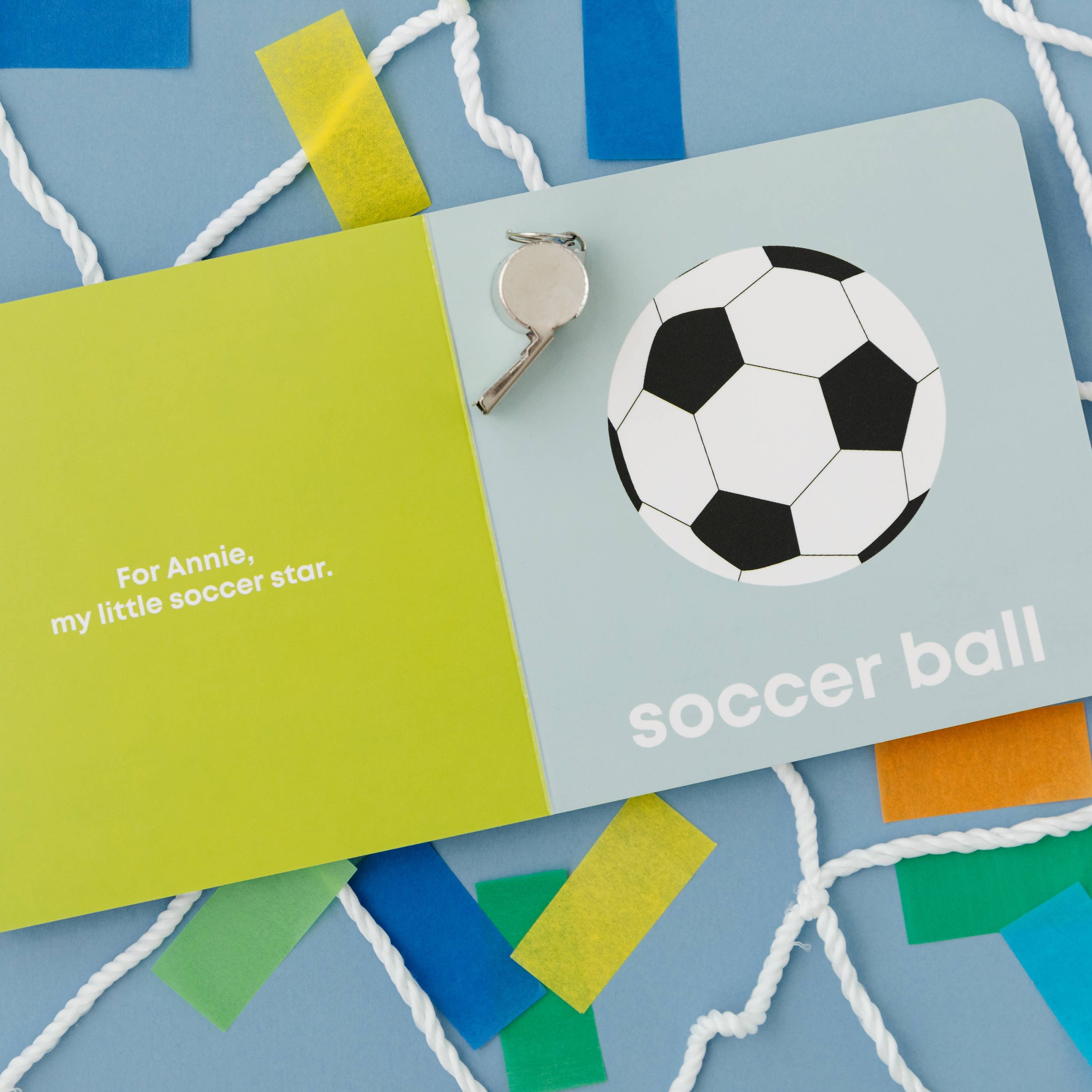 Gift card with soccer ball design and text on a blue background with colorful ribbons.