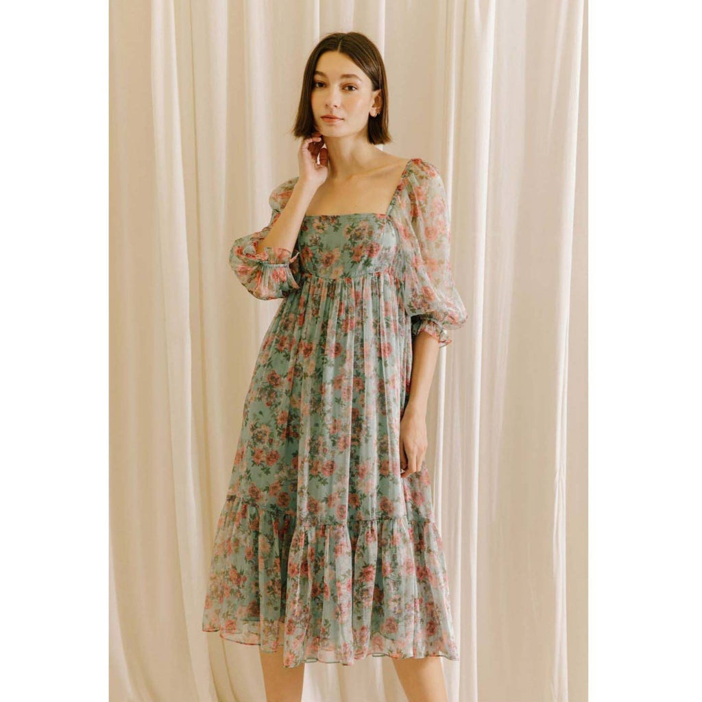 Rose floral print midi baby doll dress. It shows a square neckline, 3/4 sleeves, and bust darts. It also has a gathered empire waist, ruffled hem, and an invisible zipper.