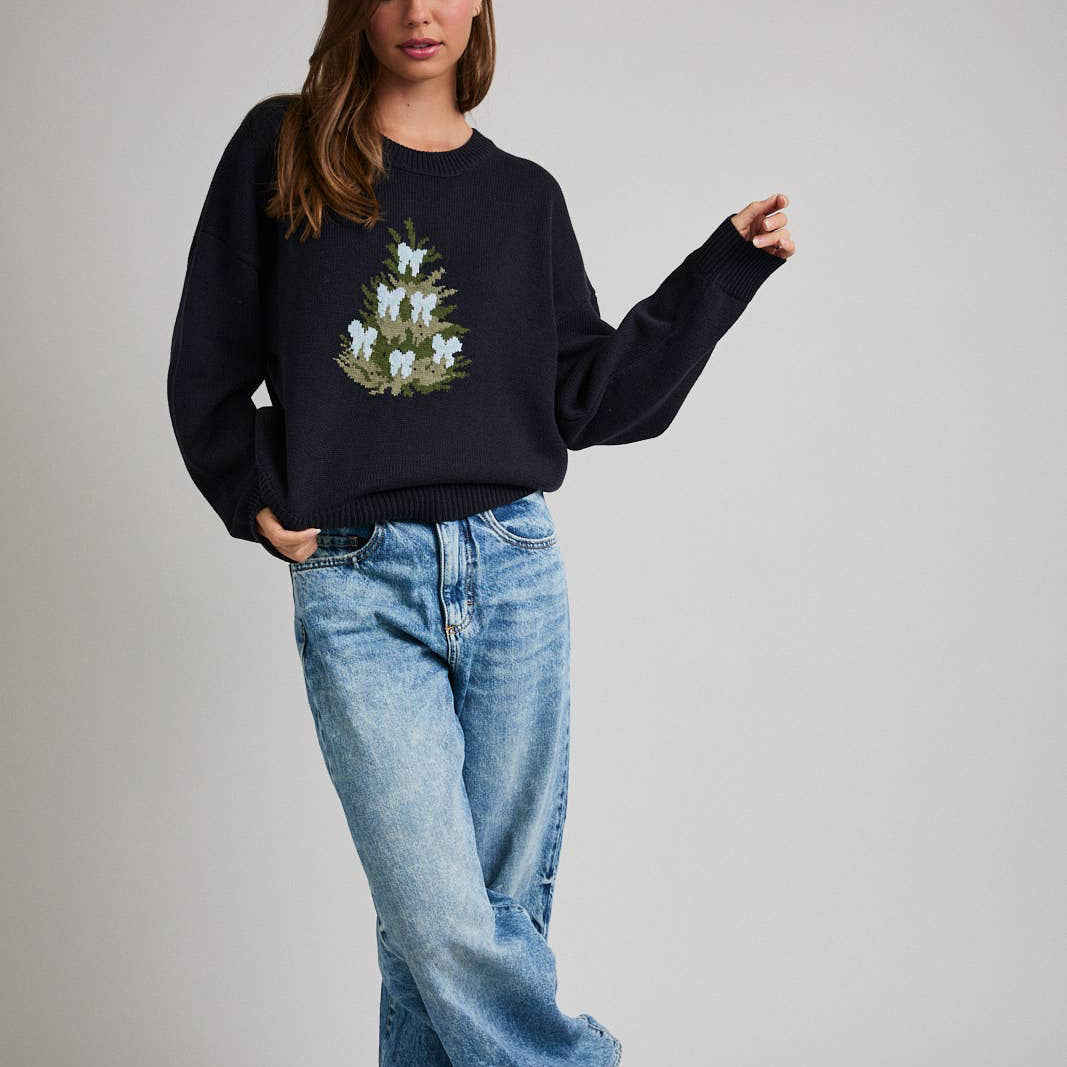 This cozy black crewneck sweater features a classic knit texture with a single, festive Christmas tree design on the front. Perfect for sharing holiday cheer, its comfortable fit keeps you warm while celebrating the season. Ideal for holiday gatherings or casual winter wear, it combines festive spirit with everyday comfort.

Details:

Model is wearing a size small; model height: 5'8", bust: 32B, waist: 24", hips: 34"