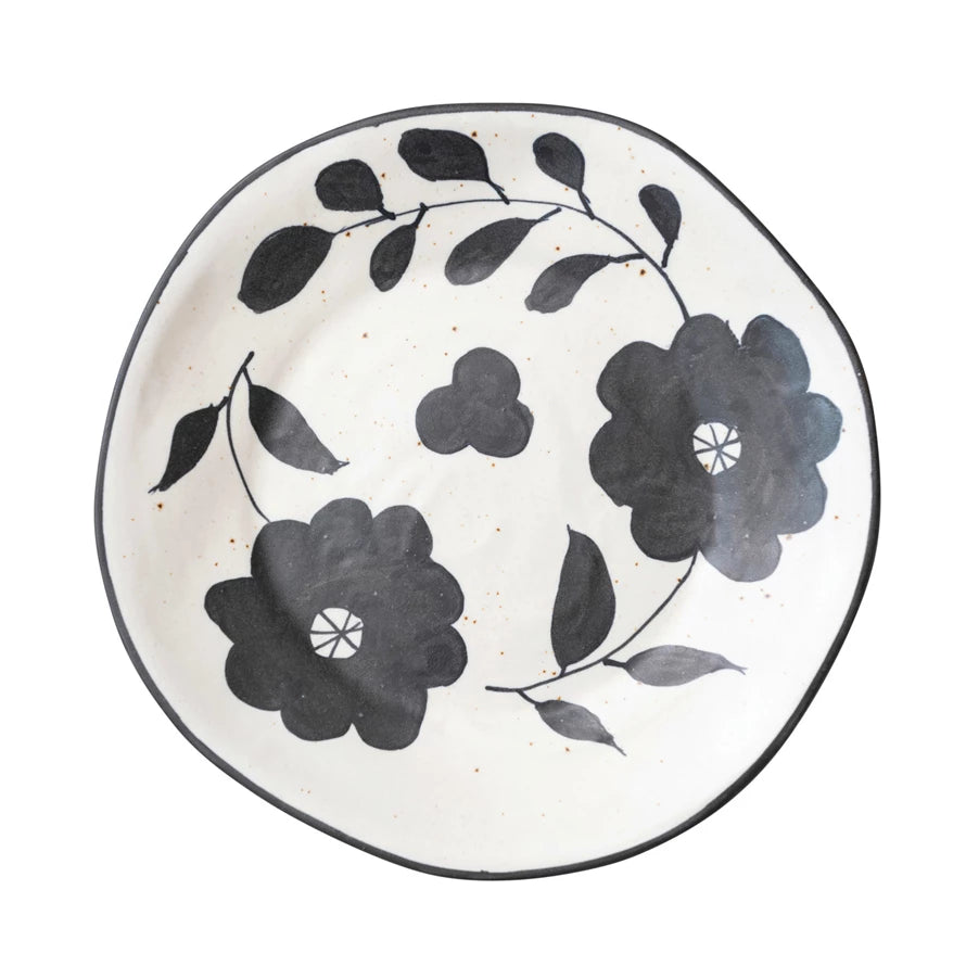 This floral plate is sure to make a statement on your table! This hand-painted stoneware plate features a unique matte black & cream speckled combination that'll be sure to make your dinner guests do a double take! So ditch the boring white porcelain, and freshen up your dinnerware with this stylish, one-of-a-kind plate.     *THIS ITEM IS PICK UP ONLY*     Dimensions  11-1/2"   Material  100% Stoneware  Matte Black & Cream Color Speckled