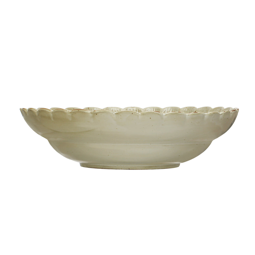 This Scandinavian-inspired stoneware bowl showcases a stylishly scalloped edge and a naturally variating reactive glaze. This piece is food safe. Dishwasher safe. Made from stoneware.