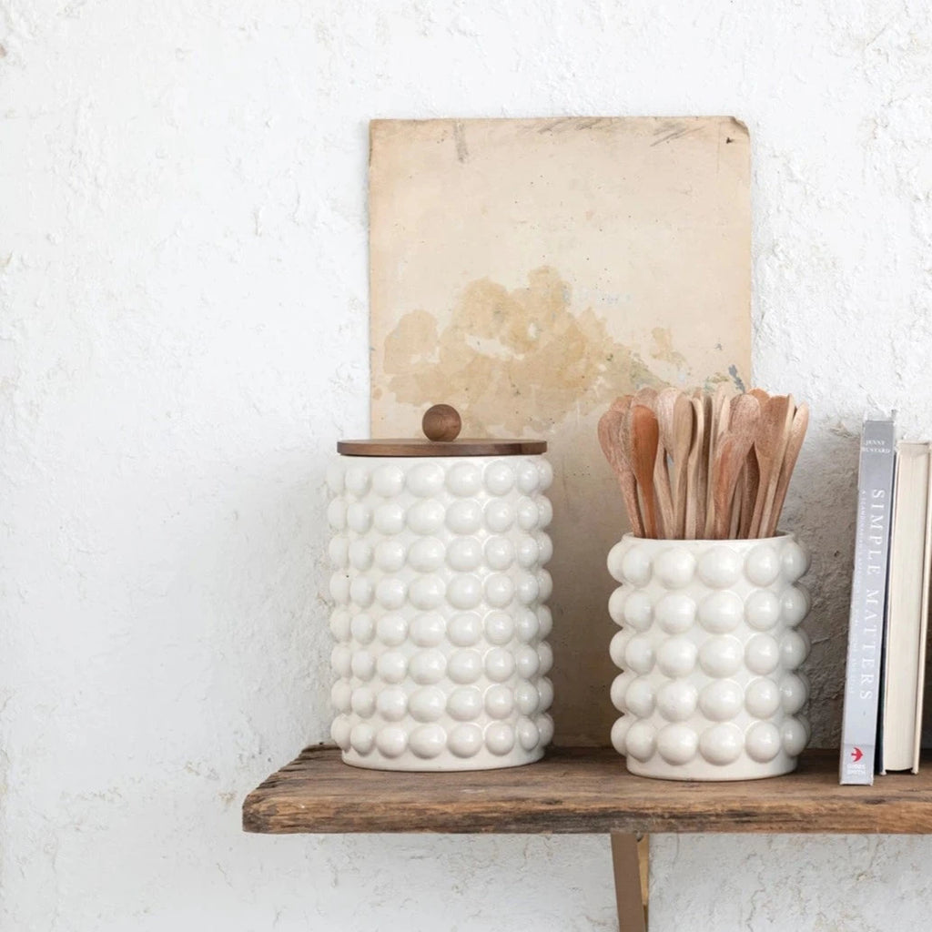 Keep your kitchen organized in style with our Stoneware Canister featuring charming raised dots and a sleek acacia wood lid. This canister, made of durable stoneware, is perfect for storing dry goods such as coffee, tea, and sugar. Upgrade your kitchen with this playful and practical addition!