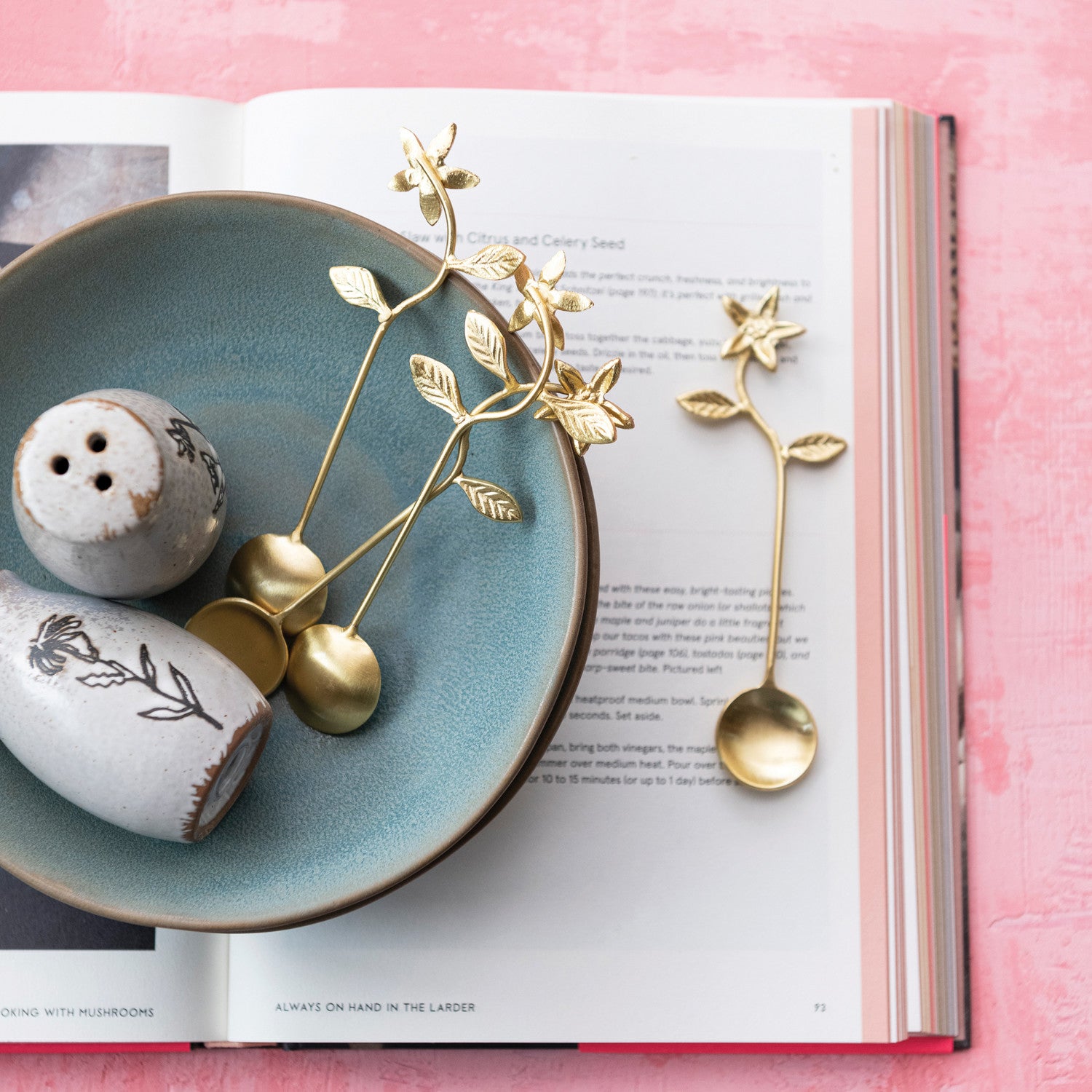 This elegant stainless steel and brass spoon features a intricately designed flower handles. A seamless blend of stainless steel and brass, combining durability with a touch of luxury, with flower-designed handles that add a charming and ornamental element to the design, elevating any dining table with their exquisite detailing.