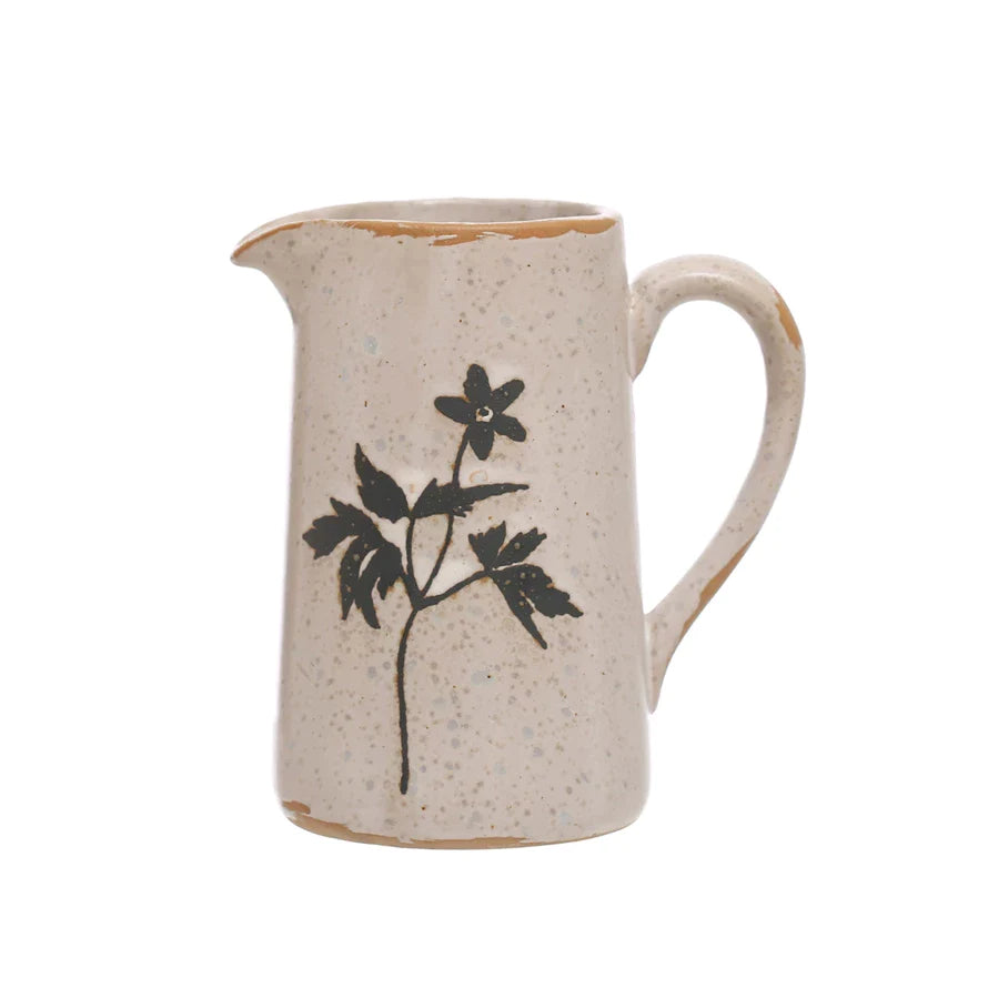 Pour your morning coffee with style using our Debossed Stoneware Creamer w/ Flowers! The delicate debossed design adds a touch of elegance to your kitchenware, while the stoneware material keeps your creamer cool for those hot summer days. Start your day off right with this quirky, floral addition.