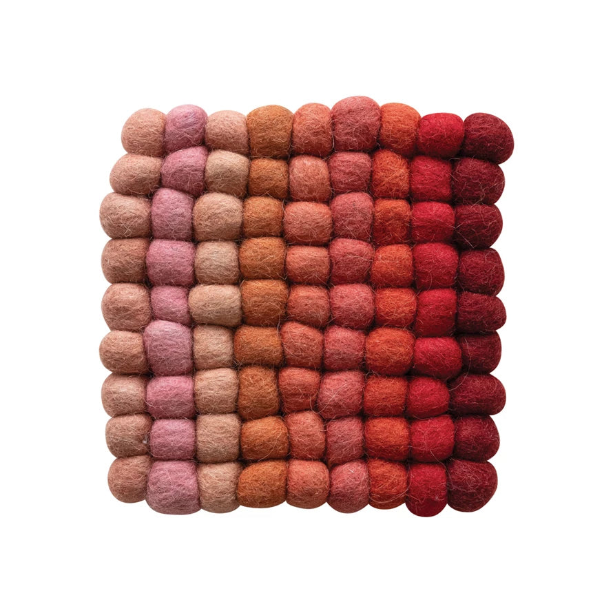 This isn't just any ordinary trivet, it's handmade with love using the finest wool felt balls. Protect your countertops in style with this unique and quirky trivet. It's the perfect addition to any kitchen, adding both functionality and a touch of whimsy.