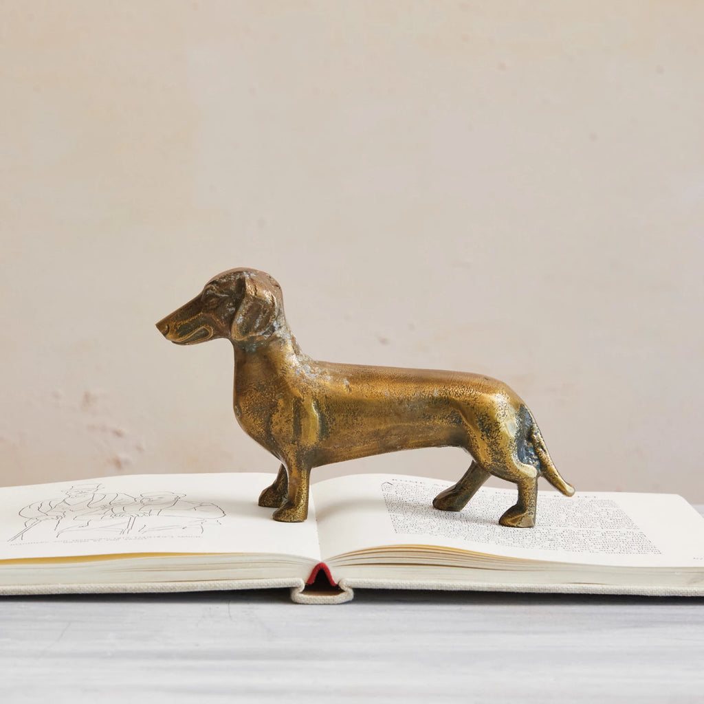 This accent decor is a must-have for dog lovers or animal enthusiasts. Made of cast aluminum, a material that is lightweight and durable. The dachshund has an antique brass finish that gives it a vintage and elegant look. The dachshund has a cute and expressive face that will make one smile.