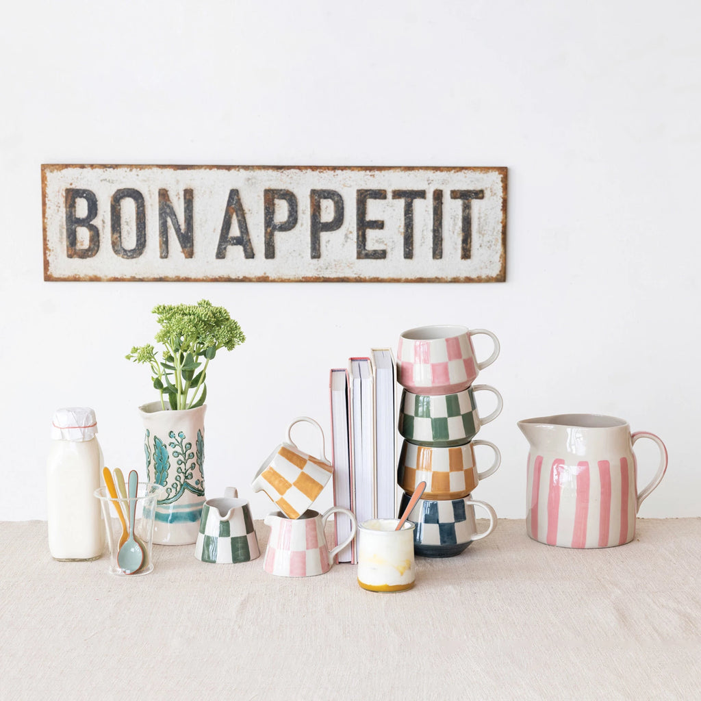 Add a playful pop of color to your morning coffee with our Hand-Painted Stoneware Creamer! Available in 3 eye-catching colors, this unique creamer is sure to bring a smile to your face. Hand-painted with love and care, each piece is a one-of-a-kind work of art. Start your day off with a little bit of fun and style.
