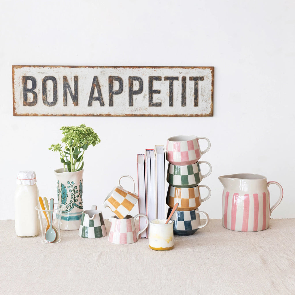 Spice up your morning routine with our Stoneware Mug w/ Check Pattern, available in 4 vibrant colors. Made from durable stoneware, this mug will keep your drink hot and your style cool. Perfect for a quirky and fun addition to any kitchen!