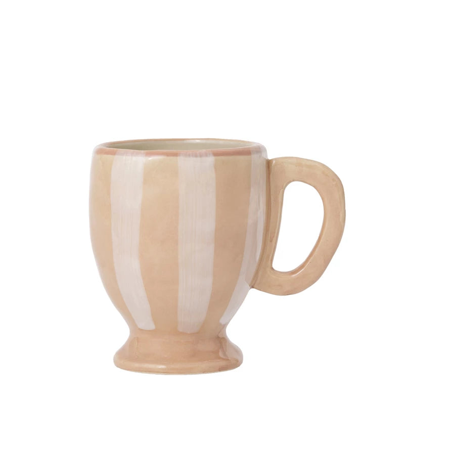 Sip your morning brew in style with our Hand-Painted Stoneware Footed Mug in White &amp; Tan Stripes. This unique mug, crafted with care, combines playful design with quality materials for a one-of-a-kind experience. Perfect for adding a touch of personality to your daily routine. (No two mugs are alike!)