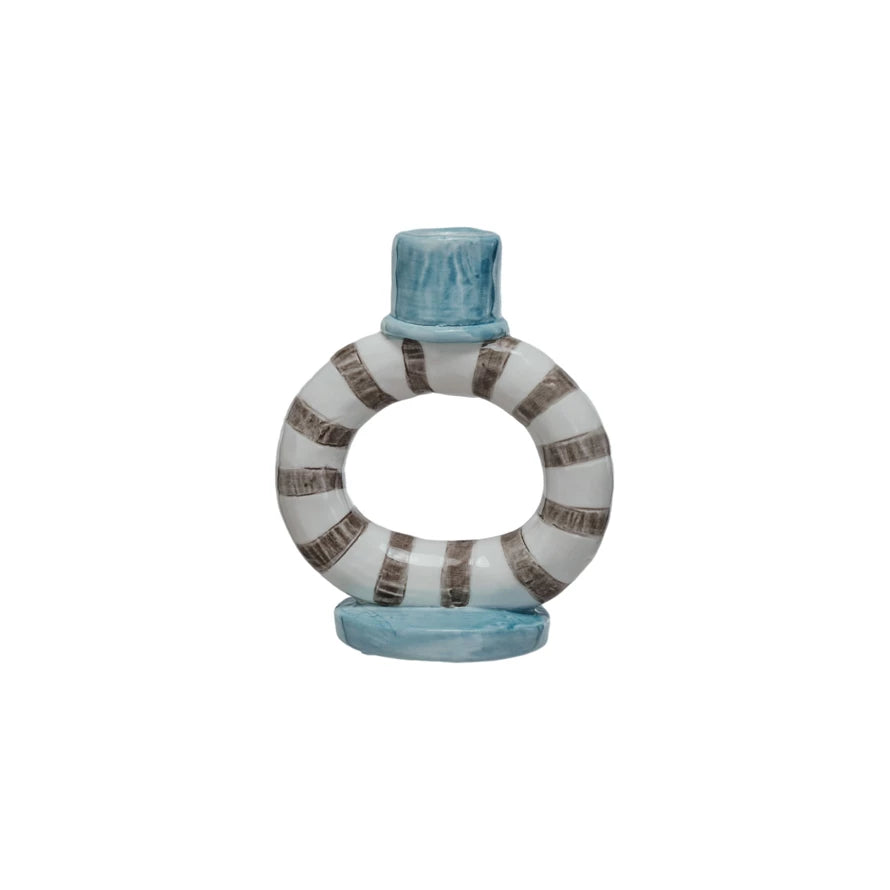 Elevate your decor with our Hand-Painted Stoneware Ring Taper Holder. Each one is carefully crafted and adorned with vibrant stripes, making it a unique and eye-catching piece. Perfect for holding taper candles, this holder adds a touch of style and functionality to any space. 4"L x 2-1/2"W x 4-3/4"H Striped