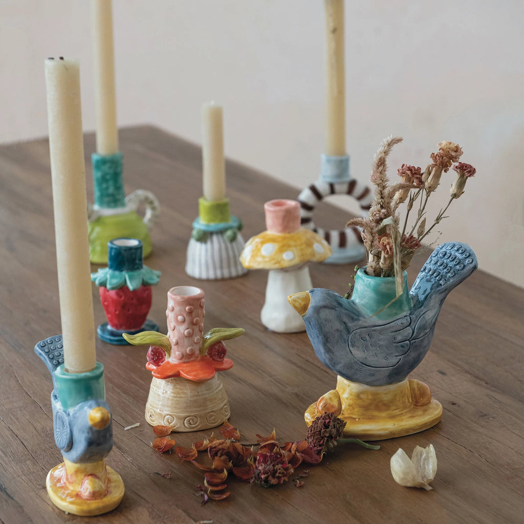 Add a pop of color to your home with this hand-painted stoneware flower taper holder. Each piece is unique and adds a touch of whimsy to any room. Perfect for holding taper candles, this holder is both functional and fun. 2-1/2" Round x 3-3/4"H