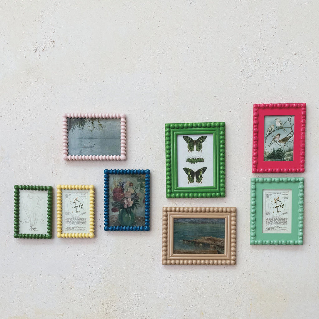 Frame your memories in style with this Painted Wood Spindle Photo Frame featuring a vintage reproduction image. The perfect combination of classic and modern, this frame adds a touch of nostalgia to any room. Show off your unique style and showcase your favorite moments with this charming frame. 