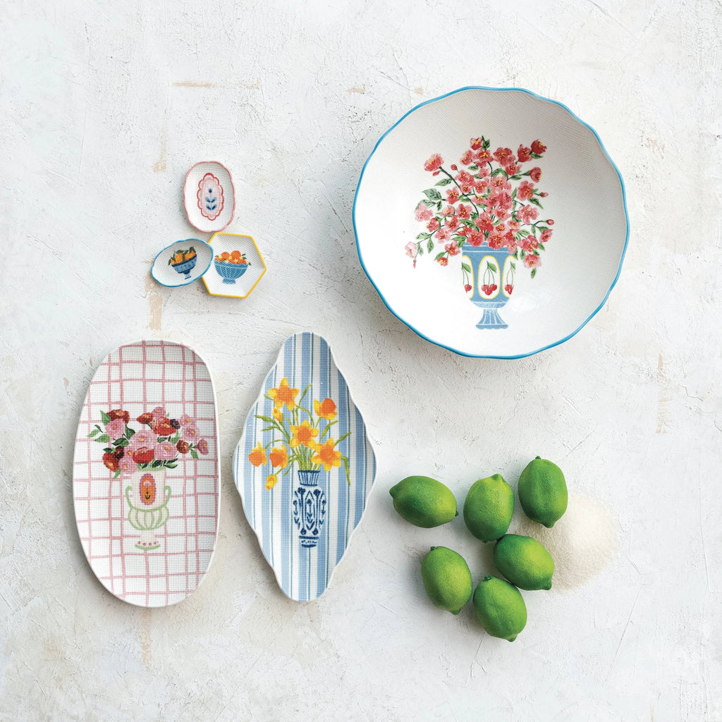 This Country Garden Stoneware Salad Bowl is a delightful addition to any home that cherishes the fusion of functionality and aesthetic charm. The white bowl, accented with a blue rim, showcases a beautiful floral design with blue blossoms and green foliage, reminiscent of a serene country garden. The cross-stitch style texture adds a unique, handcrafted quality to the piece, inviting a sense of warmth and nostalgia to any dining experience.