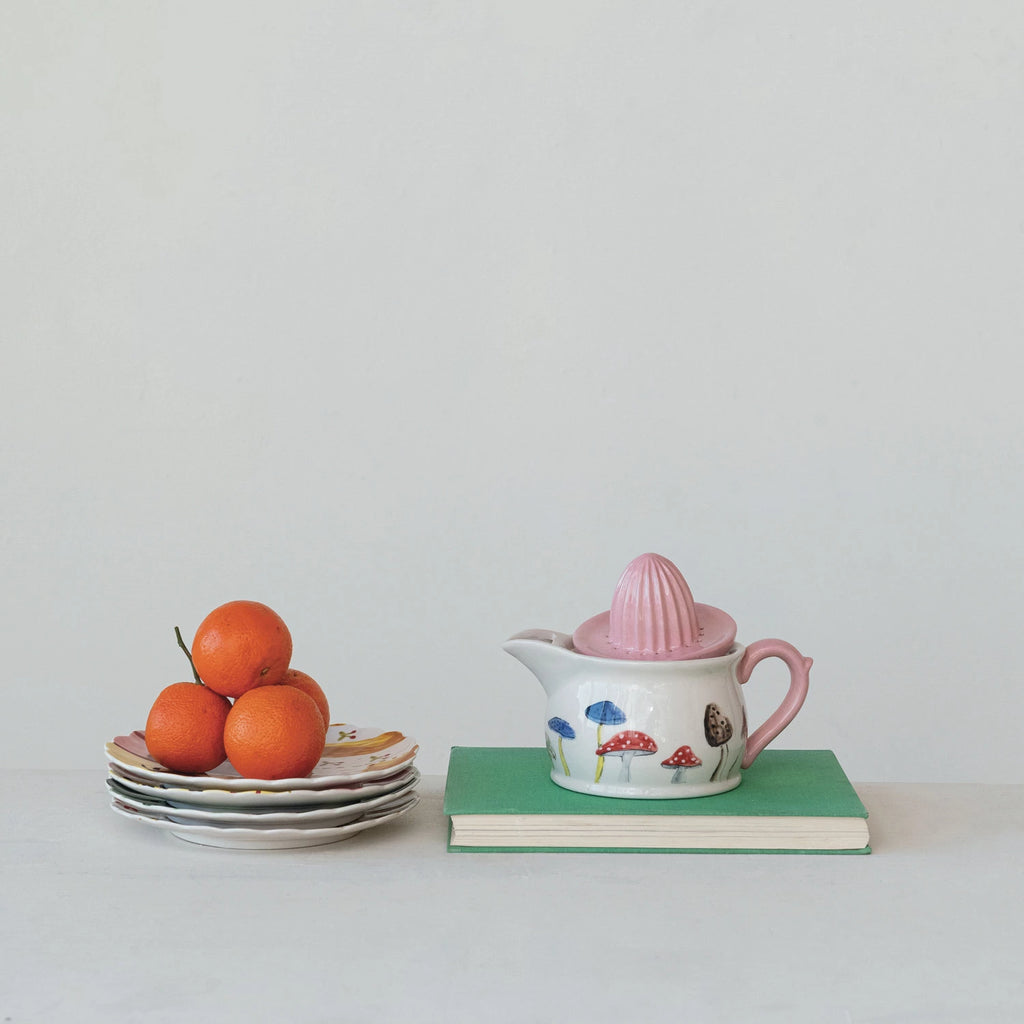 Add a whimsical touch to your kitchen with our Hand-Painted Stoneware Juicer/Pitcher! The unique mushroom design adds fun and charm while perfectly serving juice or pouring water. Enjoy a delightful and practical addition to your home.