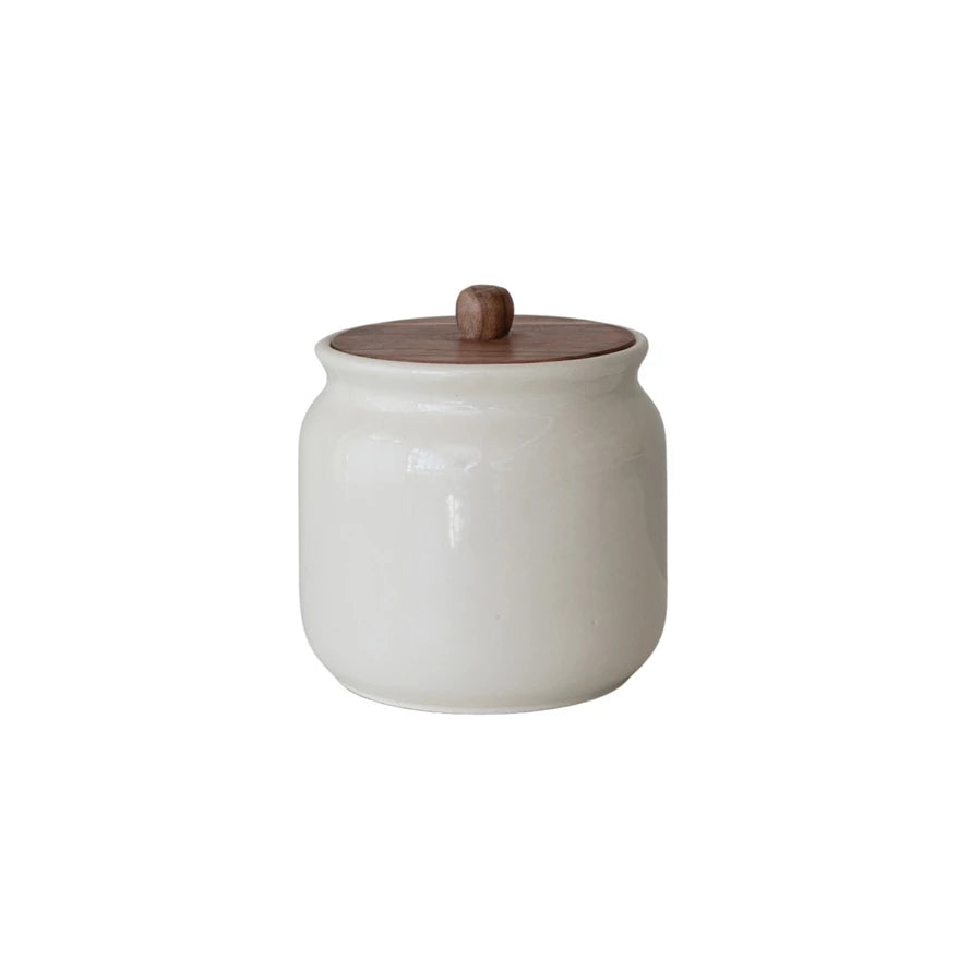 Brighten up your kitchen with this Hand-Painted Stoneware Canister topped with a warm Acacia Wood Lid! Perfect for storing everything from coffee to cookies, its unique hand-painted design adds a splash of personality to your countertop. The natural wood lid keeps contents fresh while giving your space a cozy, playful vibe. Storage has never looked this fun! 6-1/2" Round x 7"H