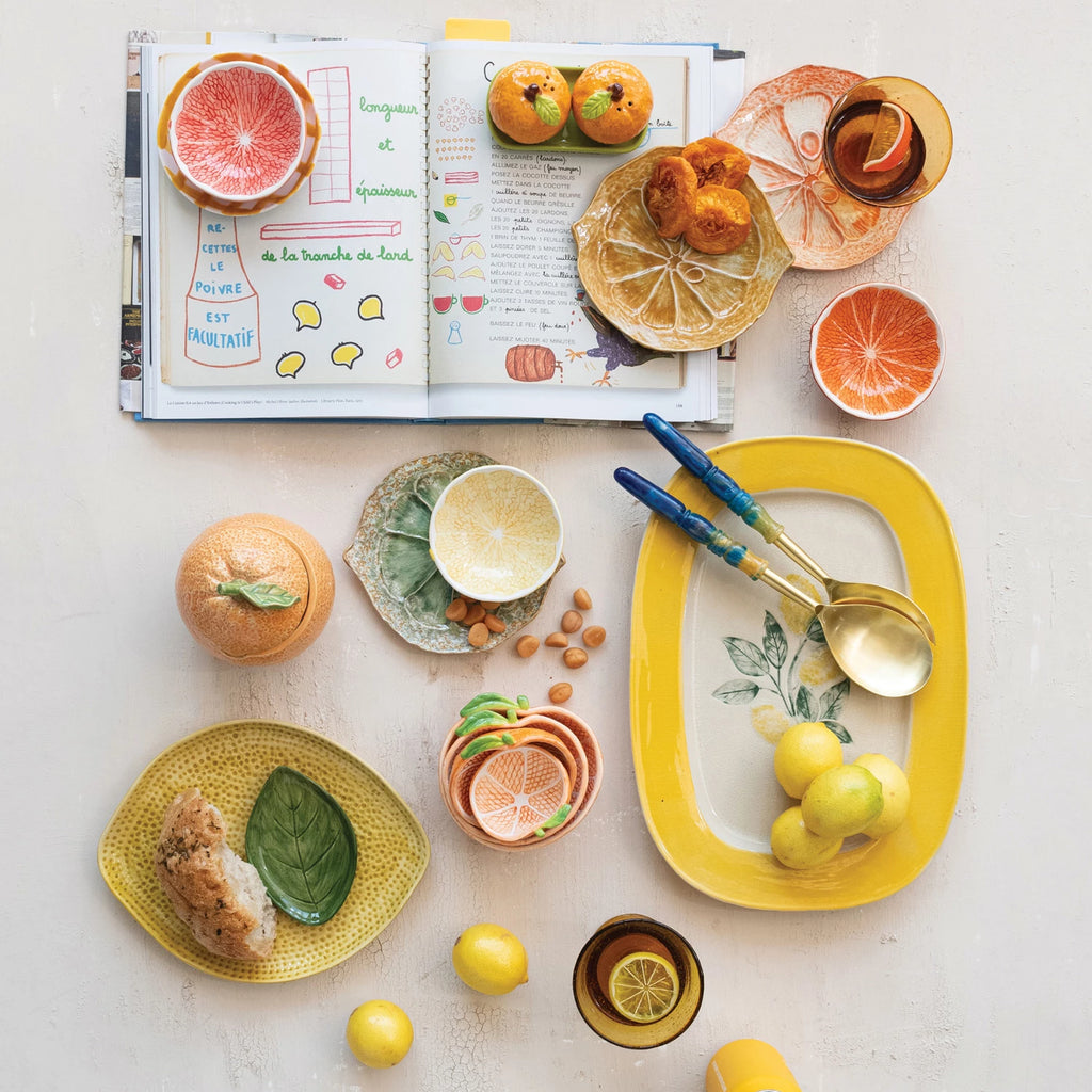 Brighten up your table with our Stoneware Citrus Shaped Plate! Available in 3 vibrant colors, this playful and quirky plate will bring a pop of fun to any meal. Made from durable stoneware, it's perfect for serving up all your favorite dishes. Add a slice of happiness to your dining experience today! 6-3/4"L x 6"W