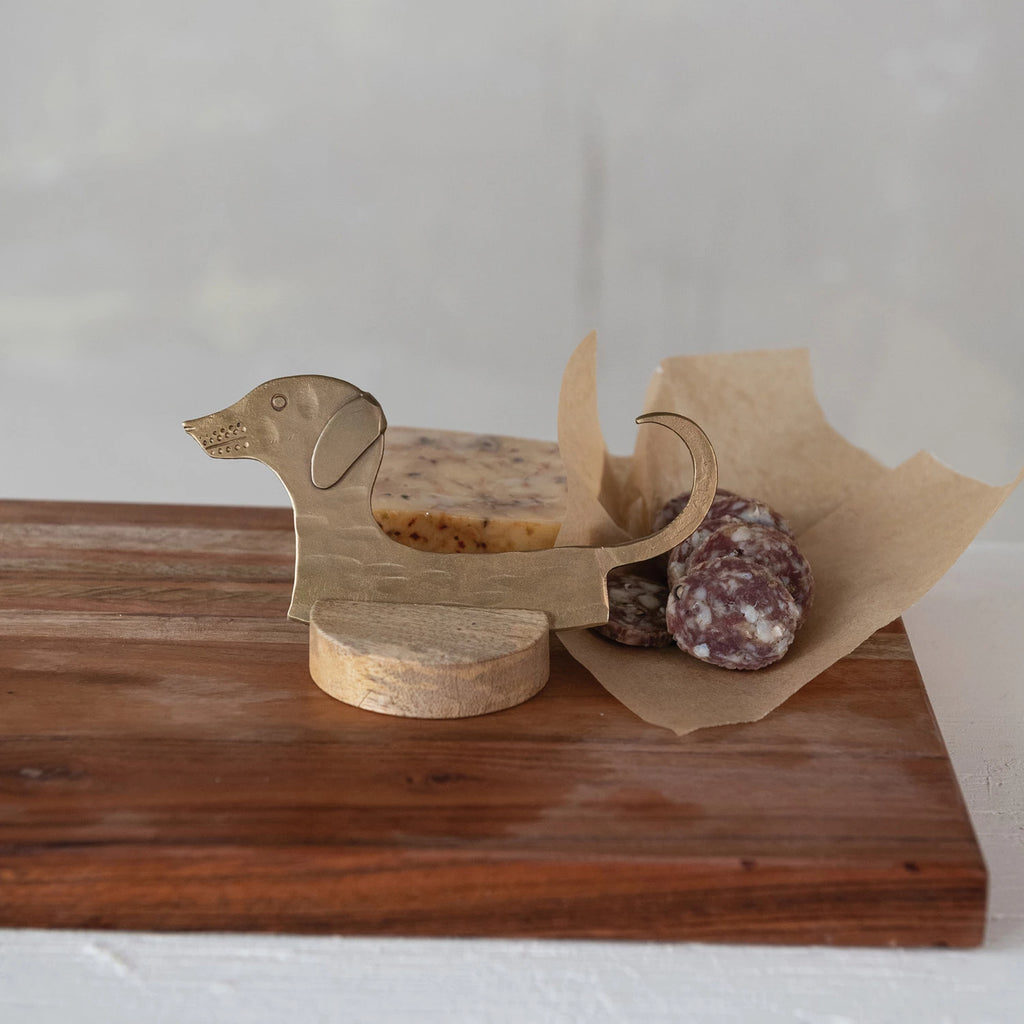 This unique Hand-Forged Metal Cheese Knife will make a statement on any cheese platter. Its sturdy construction and sharp blade make it perfect for slicing through any type of cheese. And with the included Mango Wood Stand, it's not just functional, but also a beautiful addition to your kitchen decor.