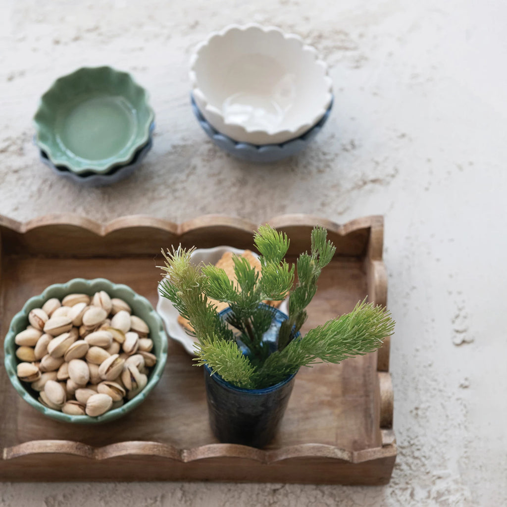 Introducing our Mango Wood Scalloped Tray, the perfect addition to your home decor! Crafted from sustainable mango wood, this unique tray features a delightful scalloped edge design. Use it to serve your favorite dishes or as a decorative centerpiece. A charming touch to any room!