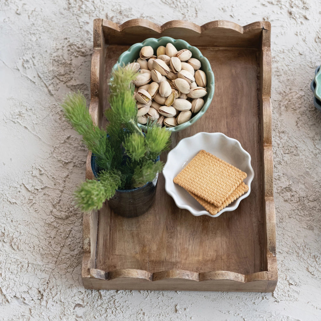 Introducing our Mango Wood Scalloped Tray, the perfect addition to your home decor! Crafted from sustainable mango wood, this unique tray features a delightful scalloped edge design. Use it to serve your favorite dishes or as a decorative centerpiece. A charming touch to any room!