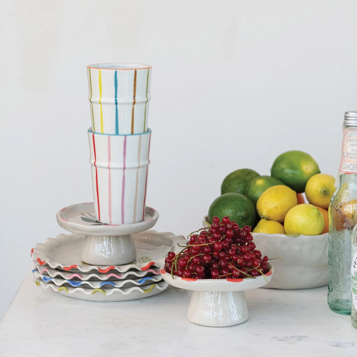 Brighten your day with this Hand-Painted Stoneware Striped Cup, featuring cheerful multi-colored stripes that add a splash of fun to every sip. Crafted from durable stoneware, it’s perfect for your morning coffee or afternoon tea, making every drink feel like a little celebration. 3-1/4" Round x 4-1/2"H. 12 oz. Green &amp; Blue Striped