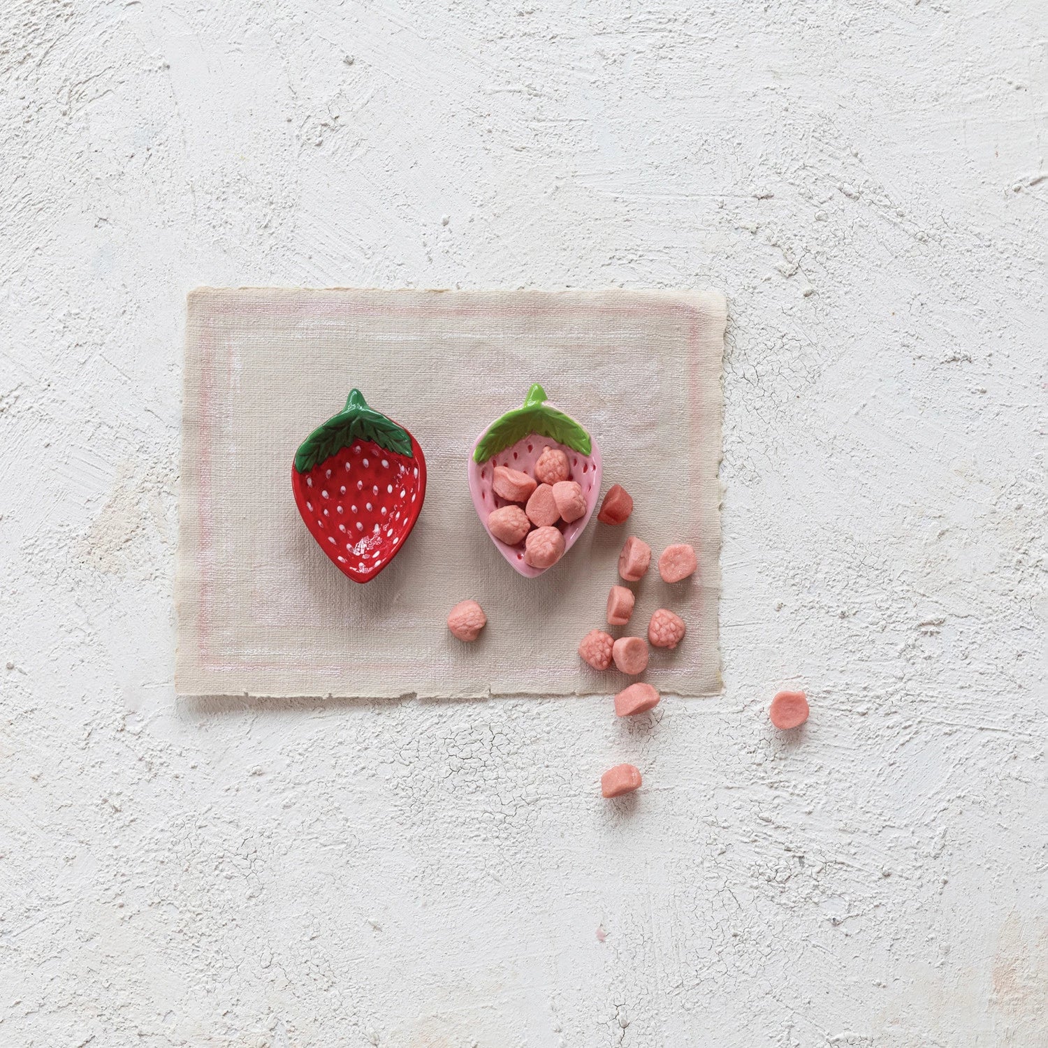 Indulge in some berry sweet serveware with this hand-painted ceramic strawberry dish. Perfect for holding small snacks or presenting a beautiful dessert, this dish adds a touch of whimsy to any table setting. Its unique strawberry shape and vibrant red color are sure to be a conversation starter.