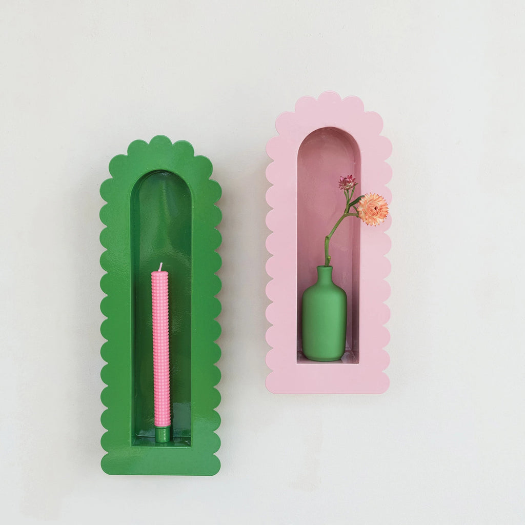 Add a touch of whimsy to your home with our Metal Taper Holder Sconce! The scalloped edge adds a playful twist to the sleek metal design. Perfect for creating a cozy ambiance with taper candles. Spice up your decor with this quirky and unique piece. &nbsp;7"W x 2"D x 20"H PINK