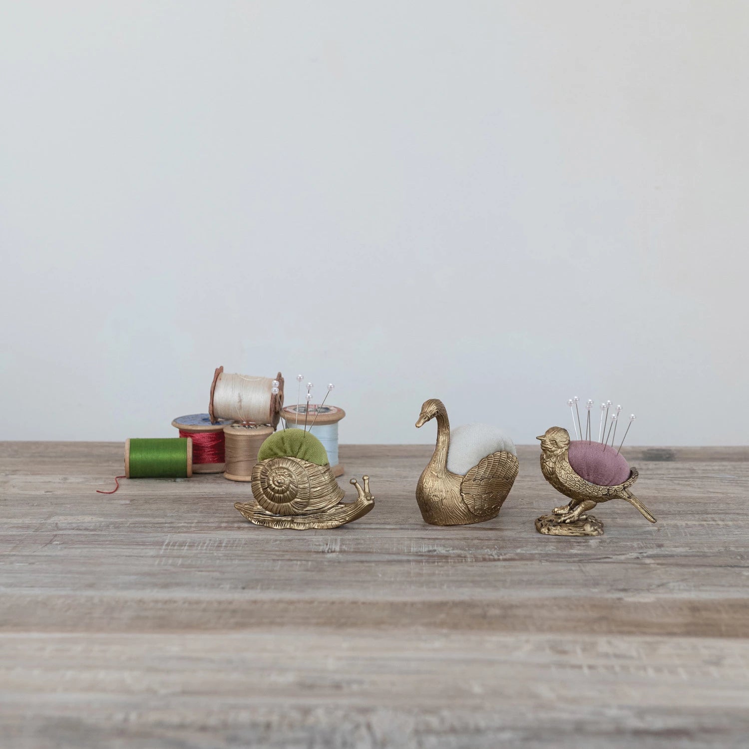 Add a touch of whimsy to your sewing kit with this Bird Velvet Pin Cushion! Soft velvet forms the charming snail shape, making it both adorable and practical. It comes with five pearl head pins, perfect for keeping your needles handy and stylish. Brighten up your crafting space with this playful and functional companion. Approximately 3"L&nbsp;