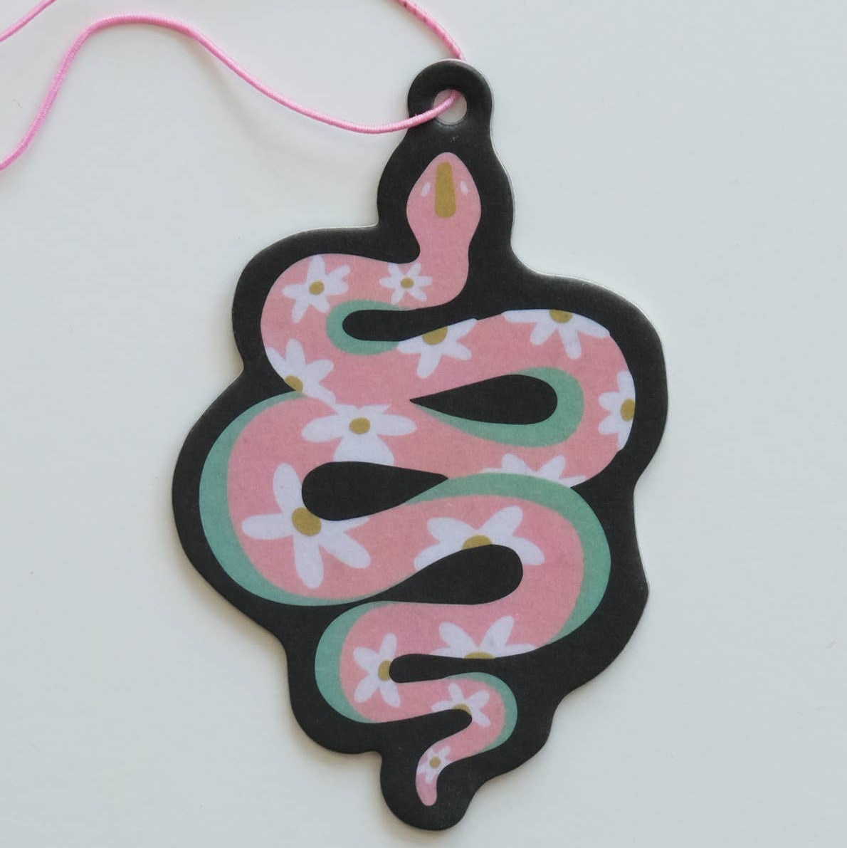 Decorative air freshener shaped like a snake with floral patterns on a white background