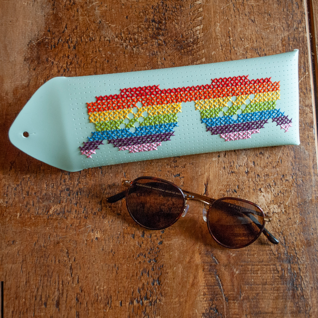 Stitch your own way - this envelope pocket is ideal as a pencil or glasses case and allows you to sew any unique design. Whether you stitch initials, a slogan or the sunglasses template included, it opens out fully for easy stitching. It also opens 2 ways, so it can open from the side or from the top - just pop the metal buttons to fold up whichever way you prefer. The Mint pouch comes with teal & navy thread &amp; needle wrapped on our pen thread-board. It includes our 3D alphabet template to add initial