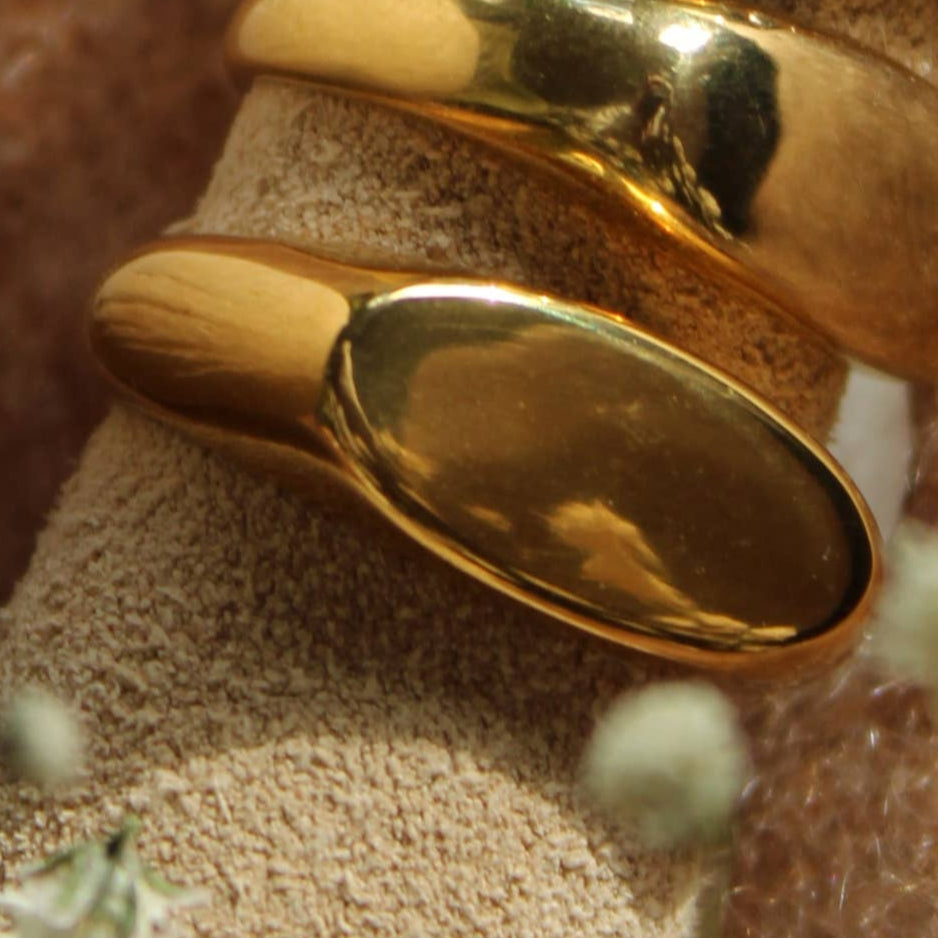 Gold ring on a cork surface with a textured brown background