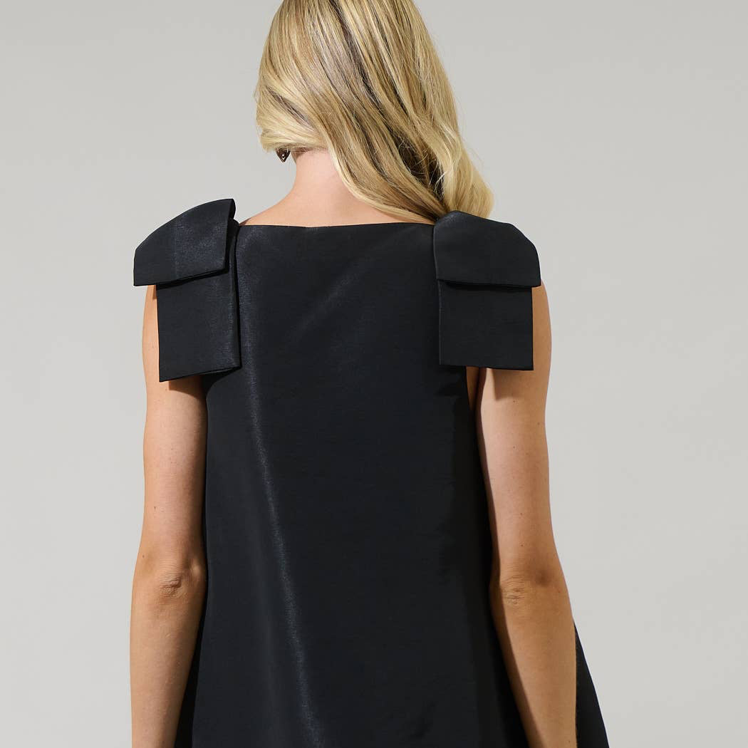 Get ready for an ultimate sassy look with this Alani Bow Trapeze Mini Dress. A shoulder bow detail frames a v neckline with a sleeveless look. The body has a trapeze style, creating a loose effect. Wear it with strappy heels and you’re good to go.

Details:

Ribbon detail
Trapeze sleeveless
Zipper
Mini
Model is 5'9" and wearing size XS
Measurements taken from size S - Chest: 19 3/4" - Length: 33 1/2"
Color: Black