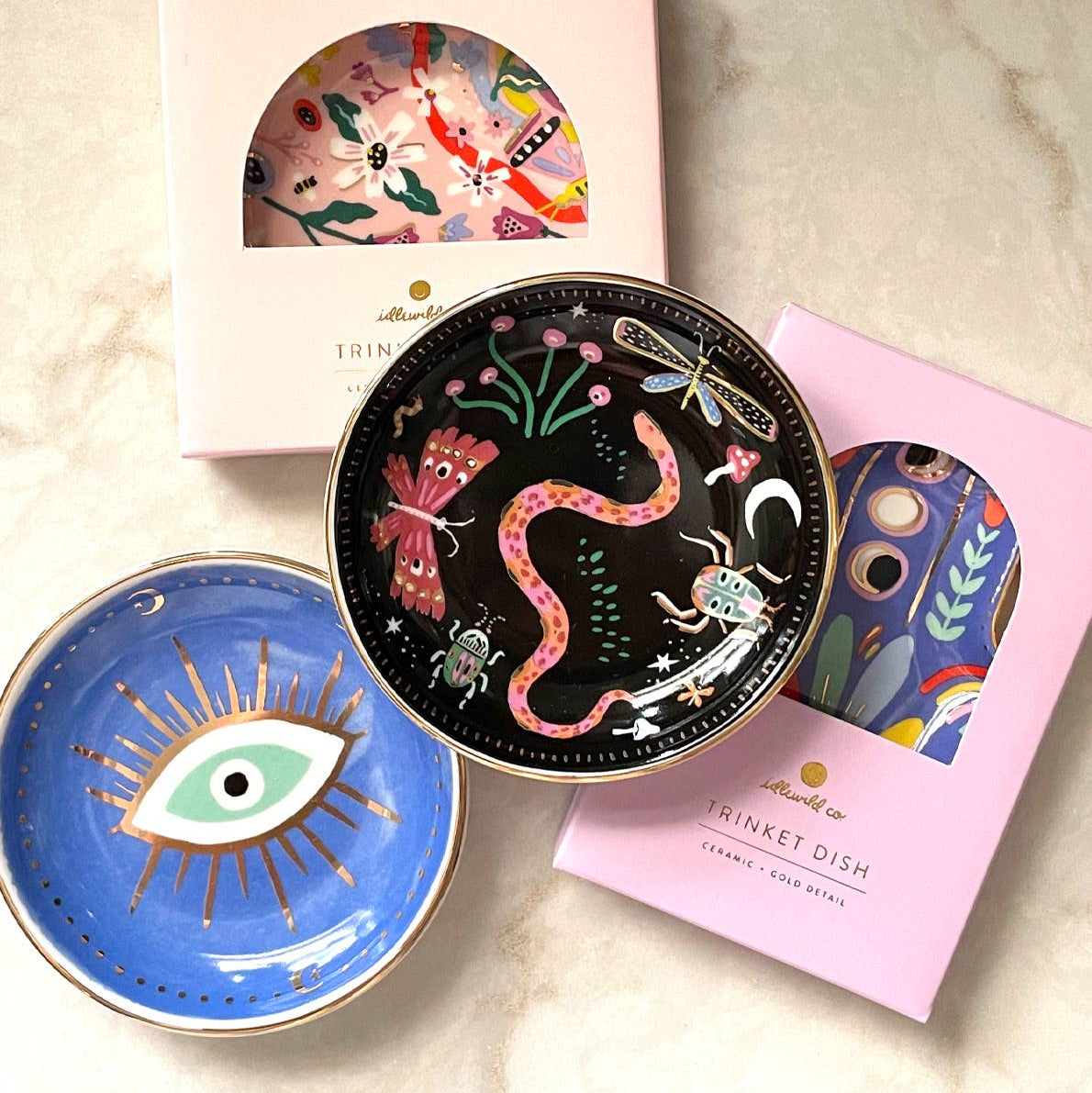 Decorative trinket dishes with artistic designs on a marble surface