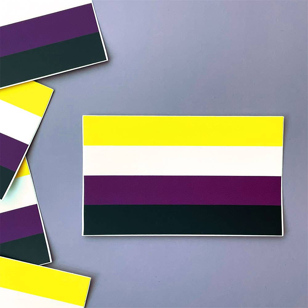 Nonbinary pride flag sticker ready for sticking on laptops, water bottles, your car, or anywhere else you can think of. Originally designed in 2014 by Kye Rowan, the nonbinary flag consists of four horizontal stripes: Yellow - representing people whose gender exists outside of the binary White - representing people with many or all genders Purple - representing people with genders considered a mix of male and female Black - representing people who identify as not having a gender. 3.3" x 2"