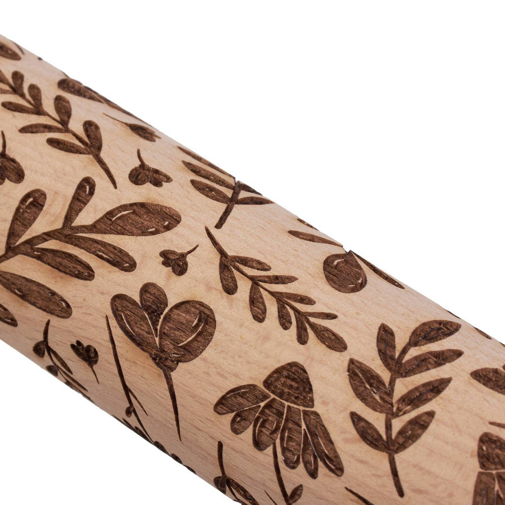 Wooden rolling pin from the Cottagecore Collection with debossed details along the roller that leave fun imprints in dough. This Floral Pattern embossed wooden rolling pin features natural beech wood debossed with a design of a variety of florals. Hand-wash recommended. 