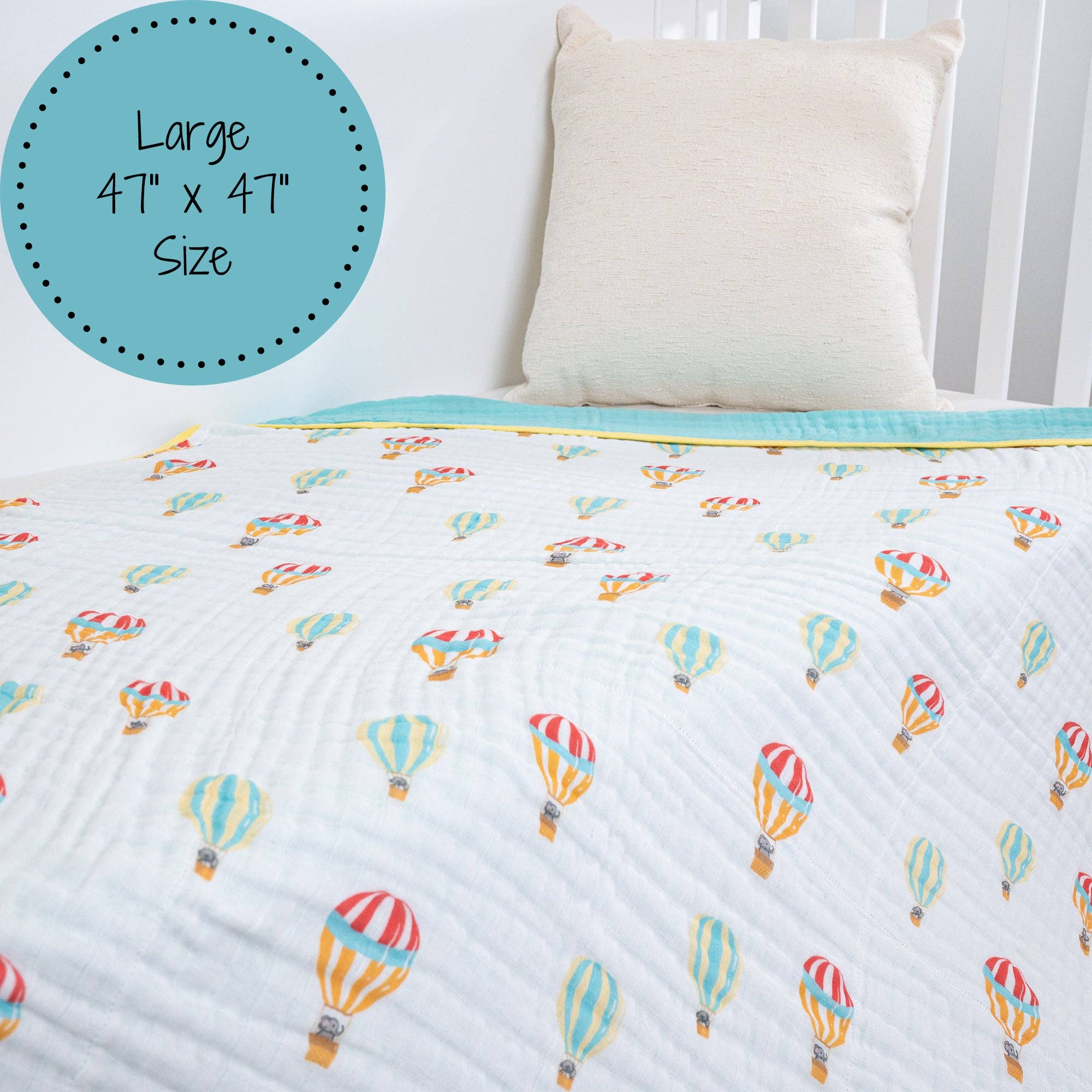 Quilt with hot air balloon pattern on a bed with a pillow